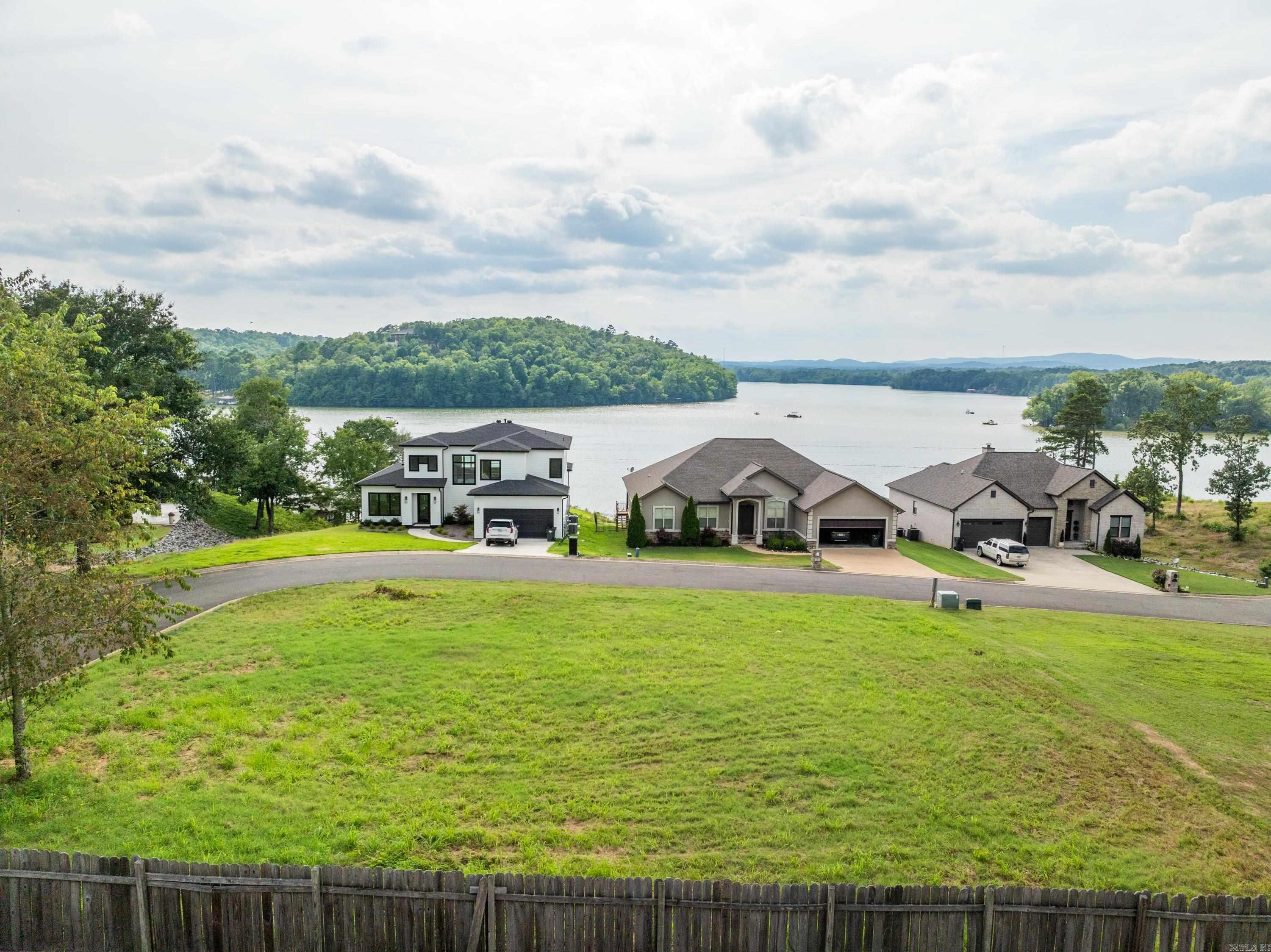 Tucked behind the gates of Oak Ridge Lake Estates lies a rare opportunity—one of the last untouched lots overlooking Lake Hamilton, where golden sunsets spill across a panoramic view. Just a minute from Hwy 270, with effortless access to both Lake Hamilton and Lake Ouachita, you’re perfectly positioned for double the adventure, serenity, and investment potential. The views are big, the vibe is elevated, and the timing couldn’t be better—before everyone else discovers it. Community boat ramp for lake access.