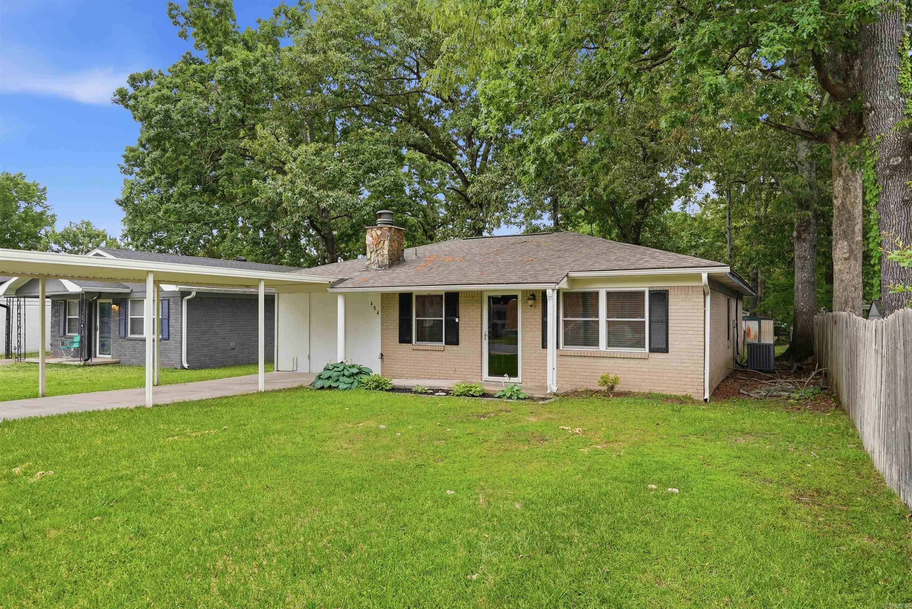Located in the Original Town of Bryant, 404 SE First Street offers convenience, charm, and everyday functionality. This 3-bedroom, 1-bath home is situated near beautiful parks like Mills Park and Bishop, Bryant schools, shopping, dining, and other local necessities. Inside, you’ll find granite countertops, a cozy gas fireplace, and a comfortable layout ready to make your own. Outside, the fenced backyard provides space for pets, play, or entertaining, while additional rear parking offers flexibility for extra vehicles, trailers, or even an RV. Whether you’re looking for your first home, downsizing, or adding to your investment portfolio, this property combines location and practicality in the heart of Bryant.