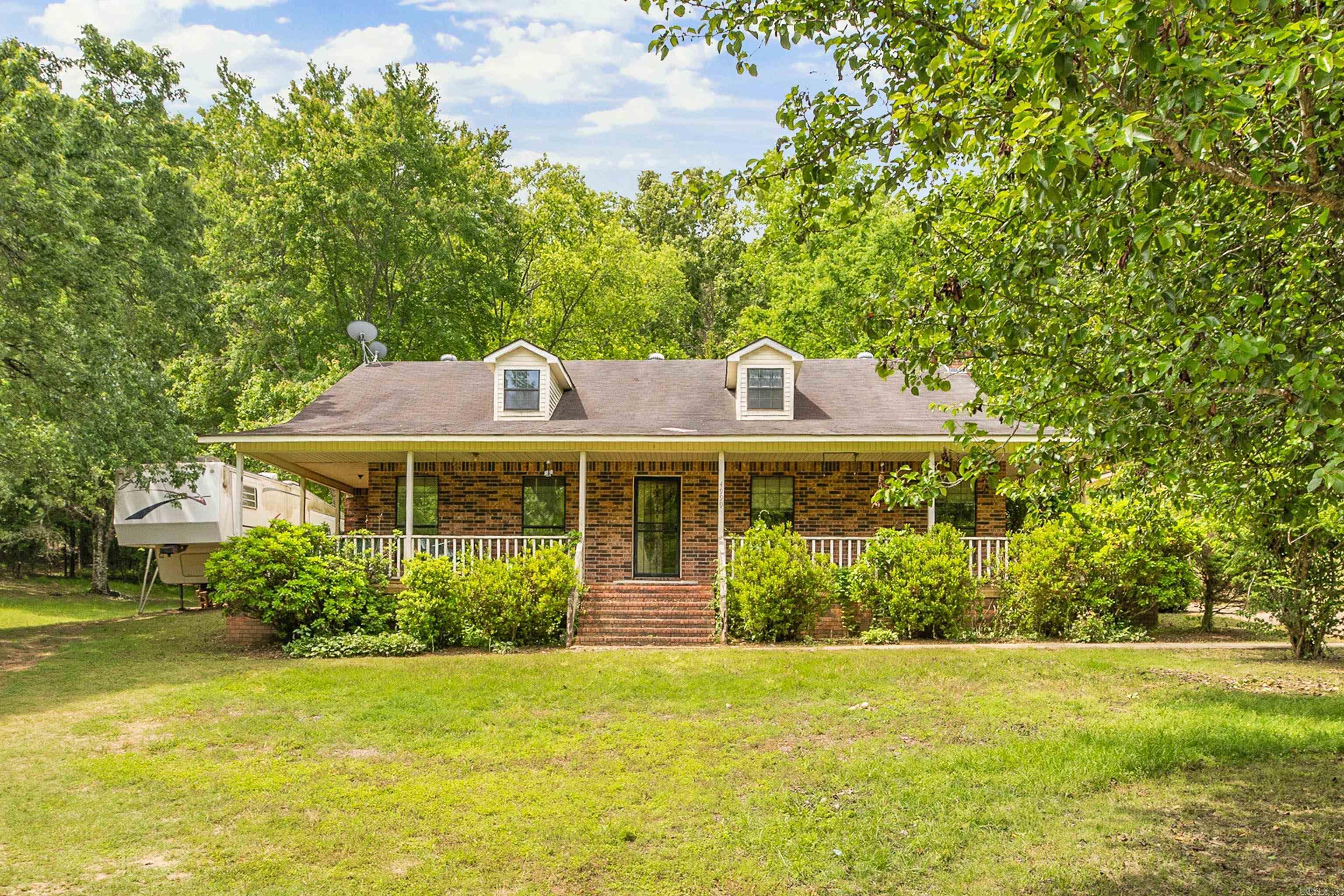 Welcome to country living with room to spread out at 4999 Brooke Cove in Benton! Situated on approximately 2.5 acres, this home offers a wonderful blend of comfort, space, and functionality. Inside, you’ll love the great layout designed for entertaining, featuring an extra large living area, spacious dining room, and a large kitchen loaded with cabinet space for all your storage needs. 3 bed/ 2 bath with 2 extra smaller rooms that could serve as an office, craft room or extra storage.  Step outside and enjoy your morning coffee on the wrap around porch, or enjoy the outdoor patio and pavilion — the perfect setup for summer cookouts, gatherings with friends, or relaxing evenings in the peaceful country setting. Outdoor shop with electricity, gives you extra space for those hobbies or extra storage. Property also has a storm cellar.  If you’ve been searching for space, charm, and a place to truly feel at home, this one is a must-see! Agents see remarks