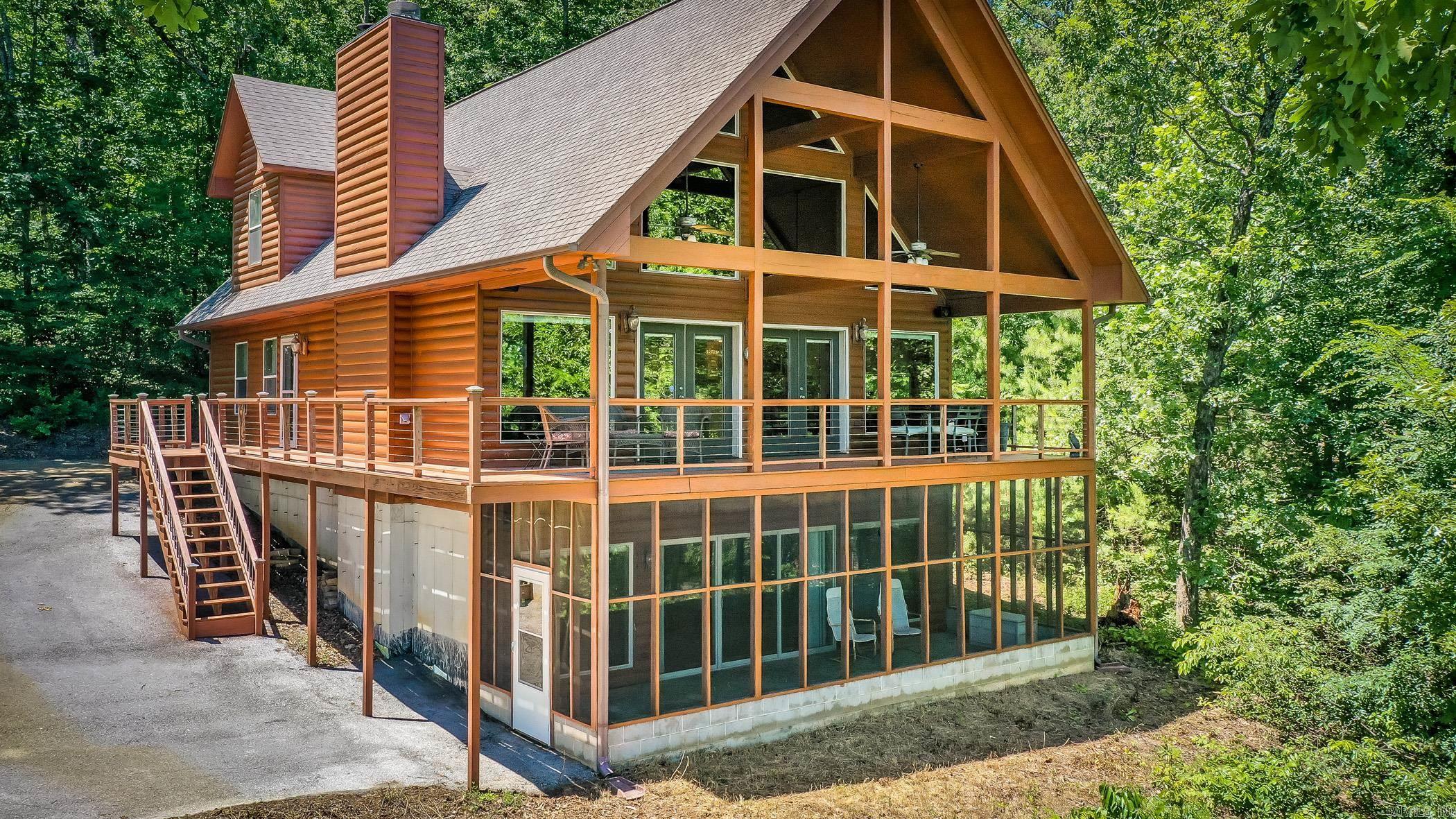 Come checkout this Furnished Lakefront Log cabin with stunning lake views! Truly setup for plenty of guests & multiple areas to entertain your guests from the open living room/kitchen combo to the Gameroom w/wet bar downstairs including wine cooler & mini fridge, to the covered porch overlooking the lake & don't forget about the beach like shoreline to pull your boat up located in the Salt Creek area of Greers Ferry Lake. Original owners since 2007 that had this cabin custom built with Cypress interior walls, hickory cabinets, hand scraped hickory floors, 2x6 walls insulated between the interior & exterior walls with Stained Pine Log siding on outside & inside walls, 2 wood burning fireplaces, 105 gallon Marathon water heater, One of the HVAC units just replaced about 4 years ago with a Trane unit. Beautiful Sunrise Views. The basement ceilings have been insulated for those late night karaoke sessions that help keep the noise down for those that go to bed early lol . (All furniture, TV’s, appliances, dishware, etc will stay except some of the seller’s personal items, see list of those items)  Only about 3.3 miles to Lacey's Marina and about 4 miles to Sugarloaf Marina.