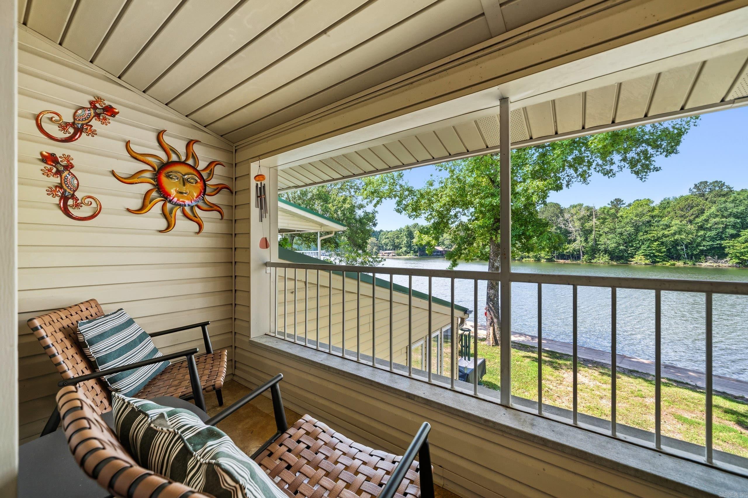 Enjoy lakefront living on beautiful Lake Hamilton with this charming 2-bedroom, 1-bath condo located in a gated waterfront community. Currently operating as a short-term rental, this property offers a great opportunity for an investor, vacation-home buyer, or anyone looking for an easy Hot Springs getaway.  The main level features a comfortable living area with a fireplace, a functional kitchen, a private bedroom, and access to a covered patio with peaceful views of the water. Upstairs, the spacious loft-style second bedroom provides additional sleeping space for owners and guests.  The condo is being sold fully furnished, making it ready to continue operating as a short-term rental or to enjoy immediately as a personal lake retreat. Residents and guests can enjoy direct access to the lakefront boardwalk and boat docking, along with shared outdoor spaces featuring a fire pit and picnic areas. Located just minutes from Oaklawn, Bathhouse Row, shopping, dining, and everything Hot Springs has to offer.  Whether you are looking for a personal getaway or an income-producing property, this fully furnished Lake Hamilton condo is ready for its next owner.