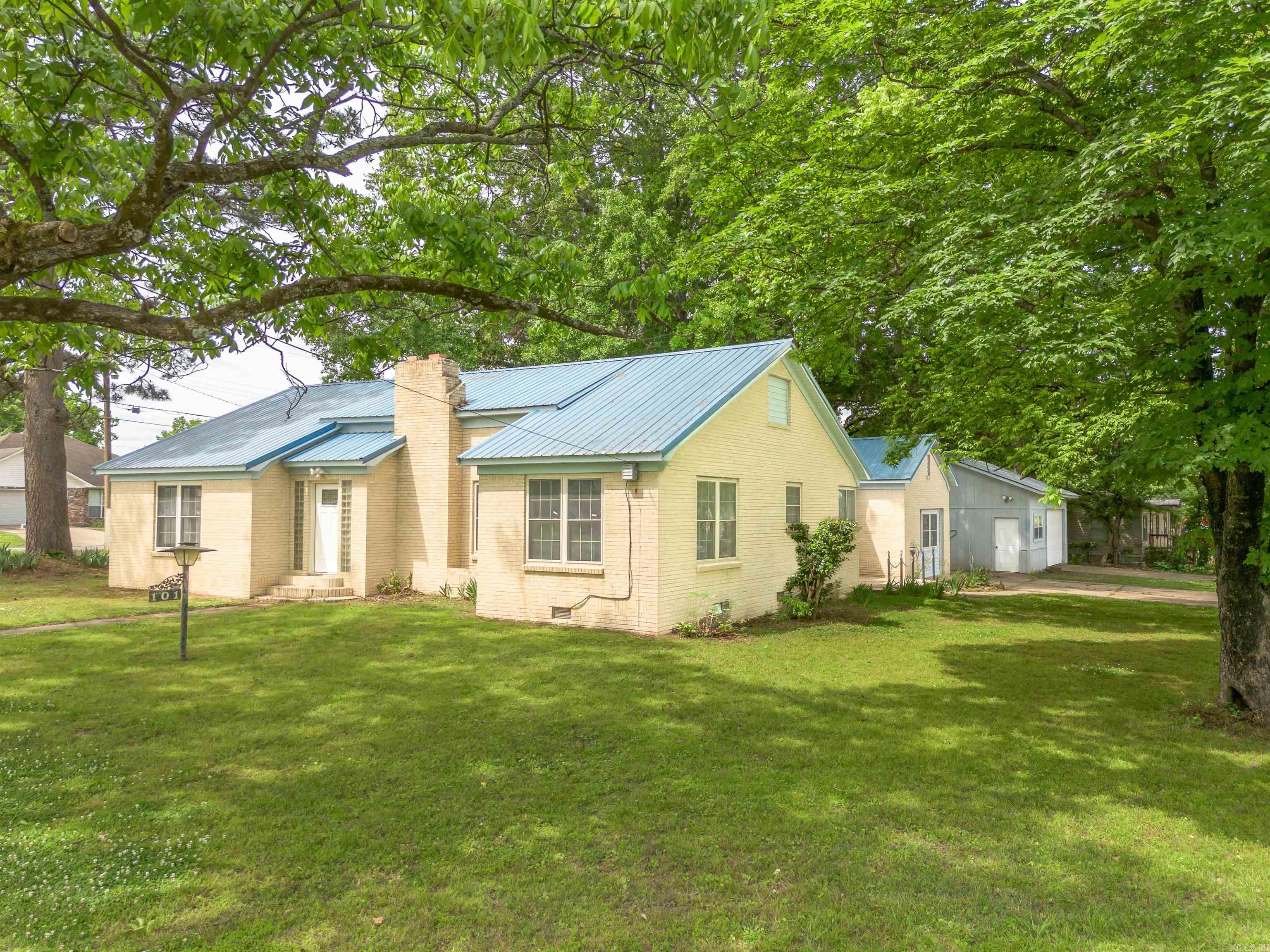 Solid brick home with metal roof featuring extensive 2026 renovations throughout. The kitchen has been fully remodeled with granite countertops, all new soft-close cabinetry, and new Frigidaire appliances, while the bathroom has been completely updated with new tile, fixtures, and cabinetry. Major improvements include all new plumbing, luxury vinyl flooring, fresh interior paint throughout, recessed lighting, updated fans and light fixtures, new doors, electrical outlets, and an electric fireplace heater. Built with older-growth materials, the home sits on a crawl space with heavy cypress wood support and offers cedar closets. Exterior features include two lots, a mature, productive pecan tree, garden space, a large shed (12' x 24'), and a two-car garage (24' x 30') with additional workshop space. Windows and the metal roof were both installed in 2014, and the home has been consistently maintained with major systems updated or recently serviced, including a gas water heater (2017) and HVAC system (2018, serviced 2026).