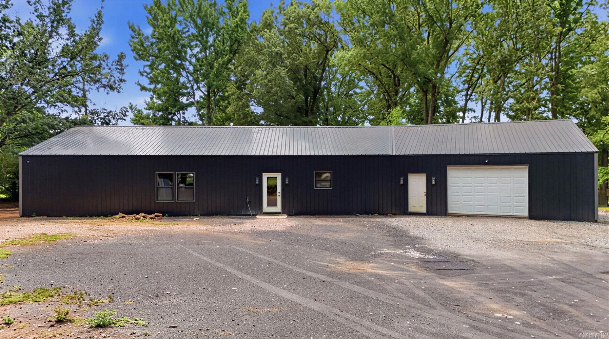 Rare opportunity to own two homes on 5.34 acres in the highly sought-after Lonoke School District! Built in 2023, the stunning shop house offers 4 bedrooms, 2.5 bathrooms, a spacious open floor plan, gorgeous kitchen with an oversized island, abundant character, a large walk-in pantry, laundry room, durable metal exterior, and metal roof. The second home, built in 1965, features 3 bedrooms, 1 bathroom, approximately 900 square feet, and is ready for your vision. Restore it as a guest house, rental, home office, or income-producing property. Each home has its own private driveway, offering flexibility and privacy. The acreage is fenced and ready for livestock, currently home to chickens, ducks, geese, goats, a pig, and rabbits. Backing up to a peaceful cattle farm and shaded by breathtaking 200-year-old oak trees, this one-of-a-kind property offers the perfect blend of country living, charm, and endless possibilities—all in a convenient location with room to grow. Selling AS IS.