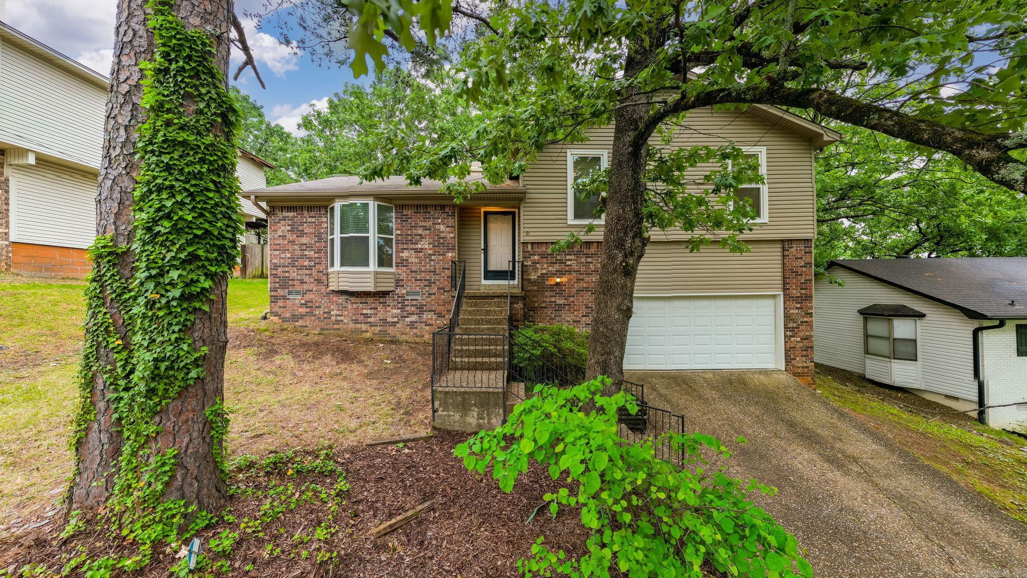 This inviting and well-maintained split-level home offers a layout with natural flow between spaces while keeping all bedrooms tucked away upstairs for privacy. The main level features a large living area and eat-in kitchen that opens to the dining space. Upstairs, the spacious primary bedroom includes an en-suite bathroom with tub/shower combo and walk-in closet.  Updates include fresh interior paint and landscaping, newer flooring (2021), newer HVAC (2023) and exterior improvements like siding, windows and gutters in 2020. Don't miss the heated/cooled workshop in the garage!  This move-in ready home offers comfort and ease from the moment you arrive. Located in LRSD, zoned for Don Roberts Elementary School. *Imagine the possibilities! Several images are digitally staged with furniture and decor, original pictures are included as well. *Agents, see remarks
