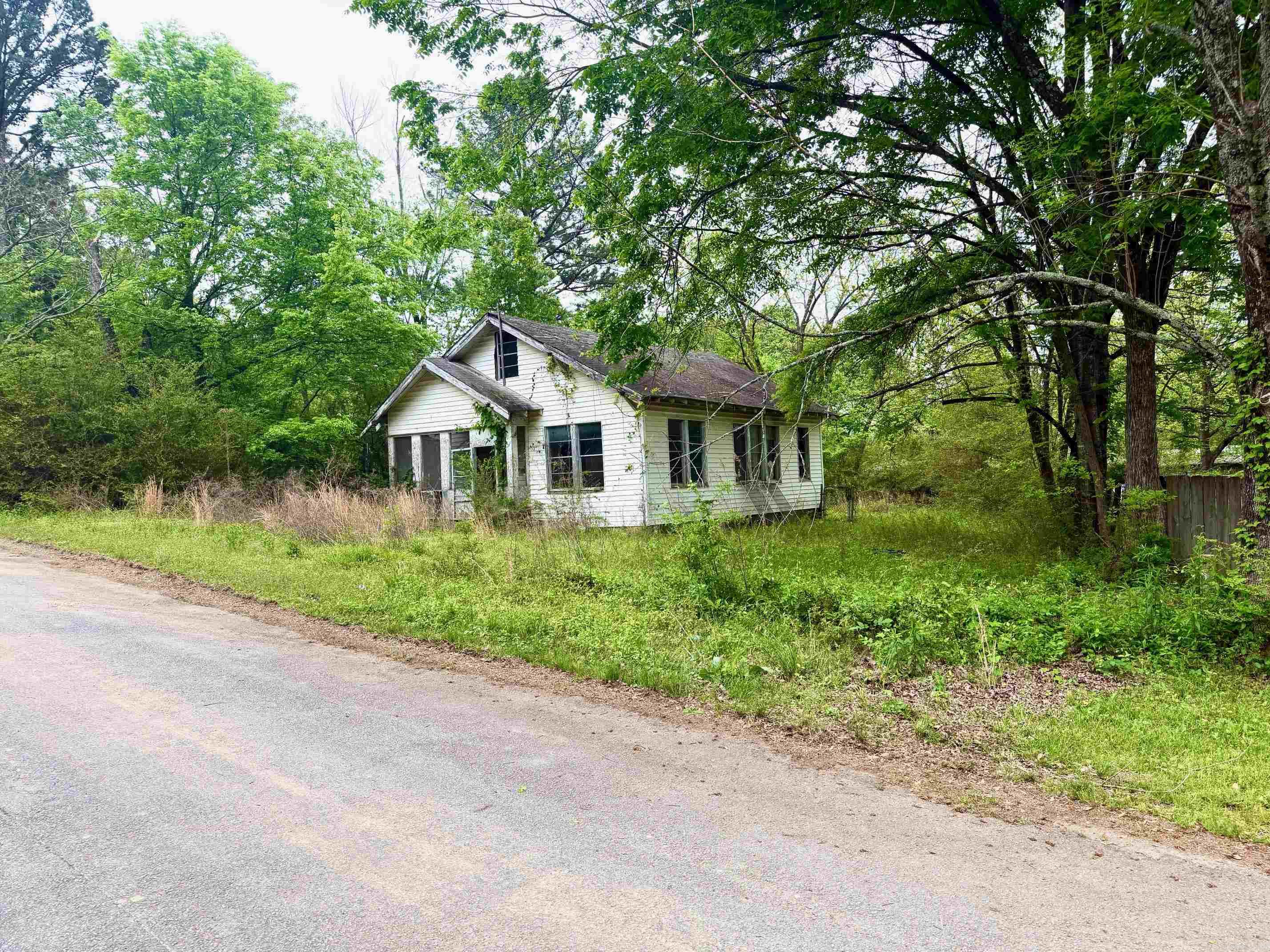 Residential lot with abandoned house.  House conveys at no value. Convenient to Burns Park and all the park amenities including playgrounds, picnic areas, tennis, ball fields, equestrian trails, camping and so much more!  See agent remarks.