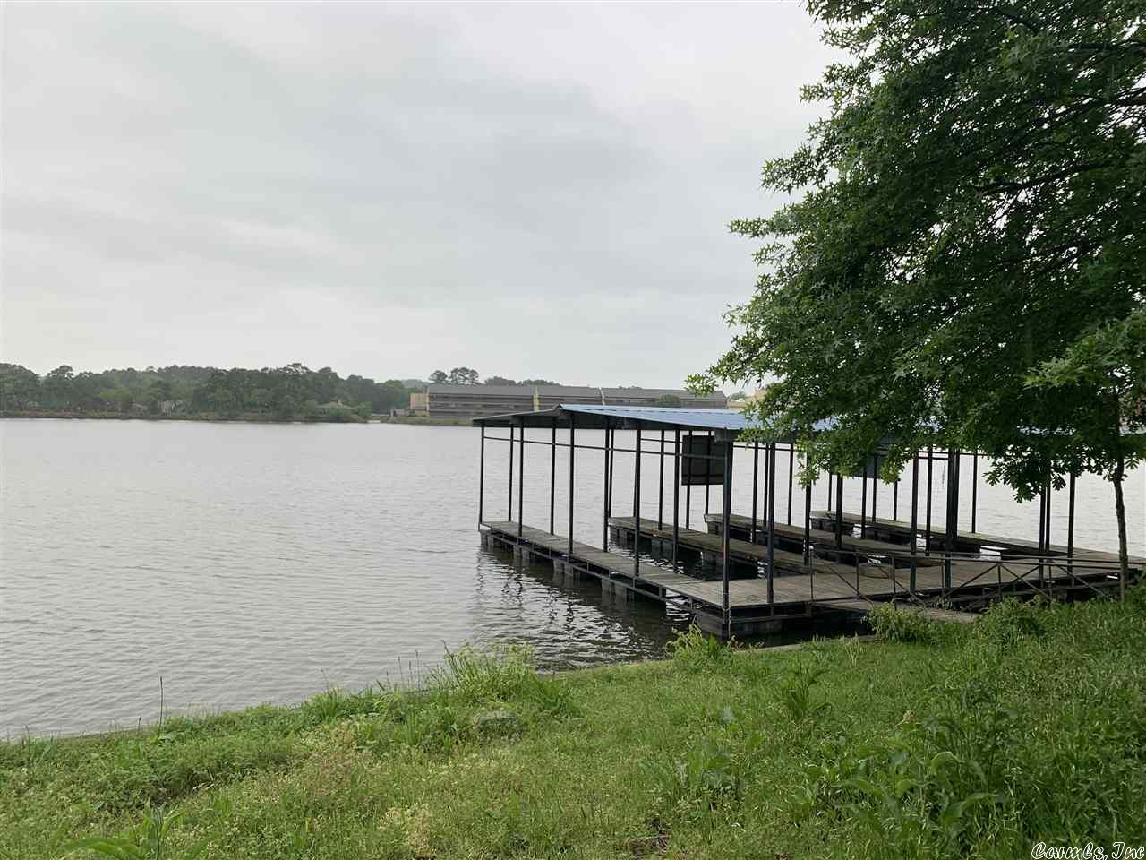 Prime development opportunity on Lake Hamilton. 176' of lake frontage with BOAT RAMP, swimming dock, and covered boat slips.  A total of 25 water meters are on site. Lot has been cleared.