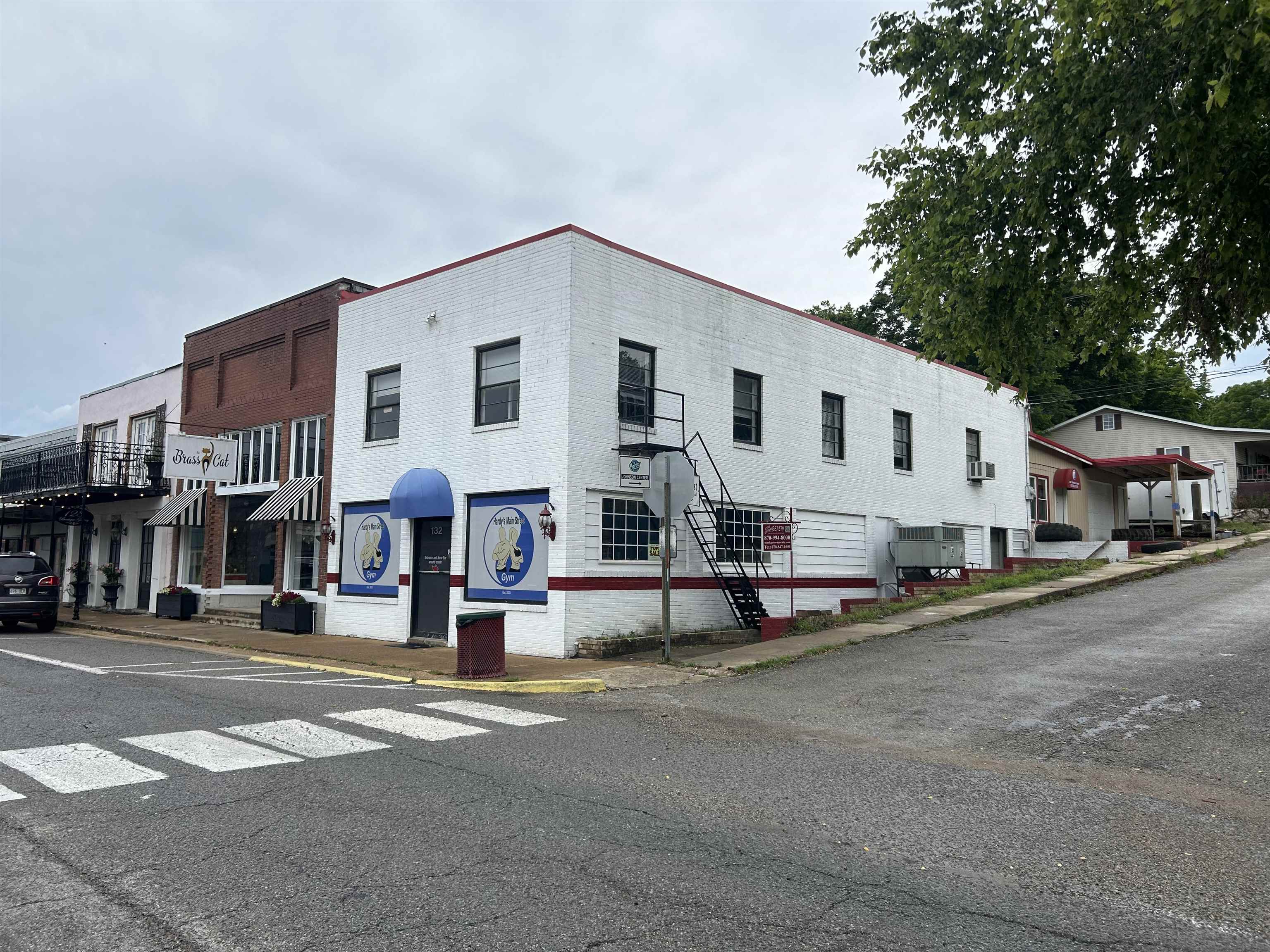 Two-story, fully functional commercial building on main street in the beautiful Spring River Town of Hardy, Arkansas. This is a high tourist traffic community which boast great opportunity for a business of your choosing in this building. It was most recently a gym and prior to that it was an antique shop. The building has been restored, inside & out. New metal roof 2024. It has two public bathrooms on main level and two on upper level. It also has a kitchen upstairs w/window ac unit. (kitchen appliances do NOT convey) Security system and keyless door entry system does convey. The back entrance is handicap accessible with a ramp going to the upper level. Also attached to the rear of building is a one car garage/work-shop with a garage door. There is room behind garage to park two vehicles. There is a lot of foot traffic here and vehicle traffic as well! Traffic consist of tourist enjoying our small Spring River community & other attractions along with locals & weekend travelers. Other local businesses consist of restaurants, clothing, crafts, antiques, retail, ice cream/candy shop and kayak rentals. Opportunity Awaits!
