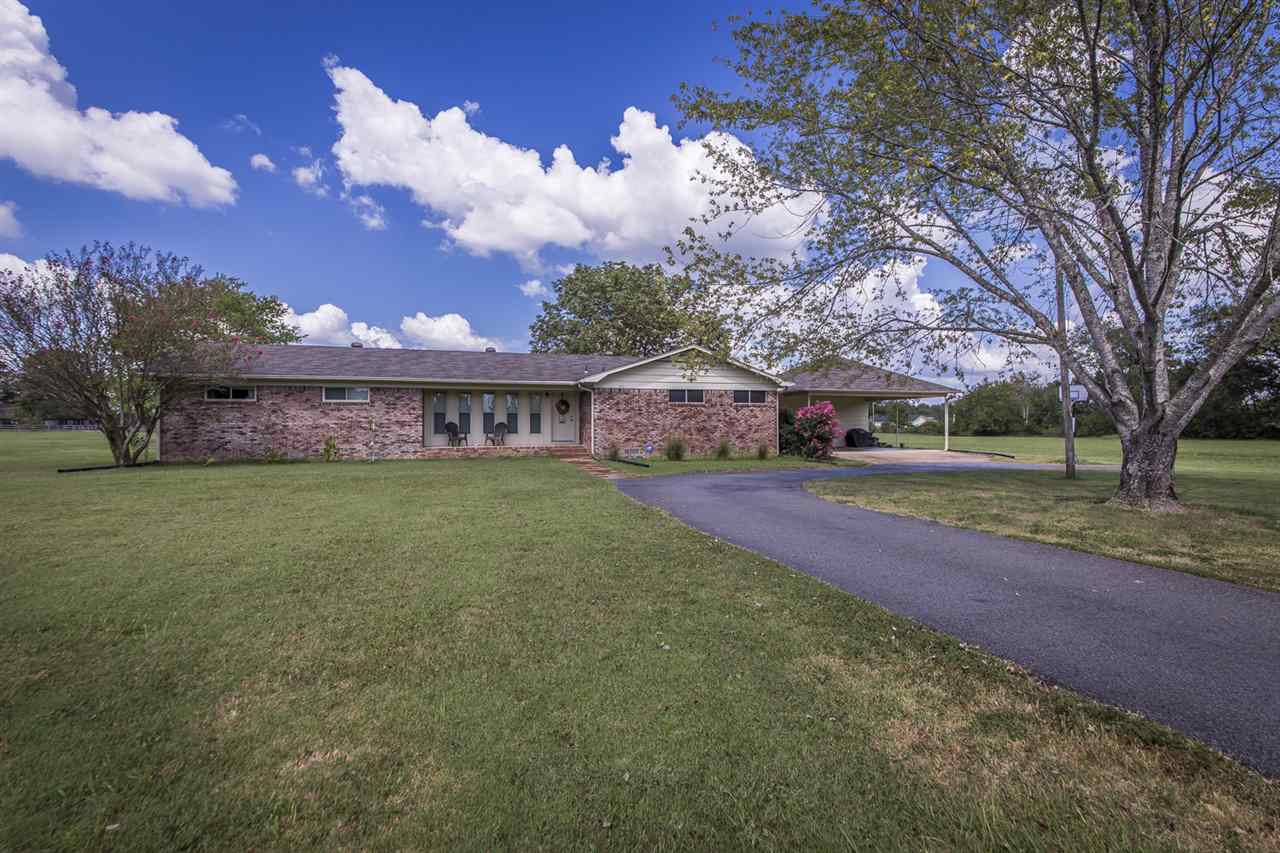 Beautiful country home with acreage! Split bedroom plan on 4+ acres.  Completely updated kitchen- granite, breakfast bar, double oven, wall of cabinets with pullouts and double pantries. Large laundry/ mud room with extra storage throughout the home. Huge 2 car carport with storage room.