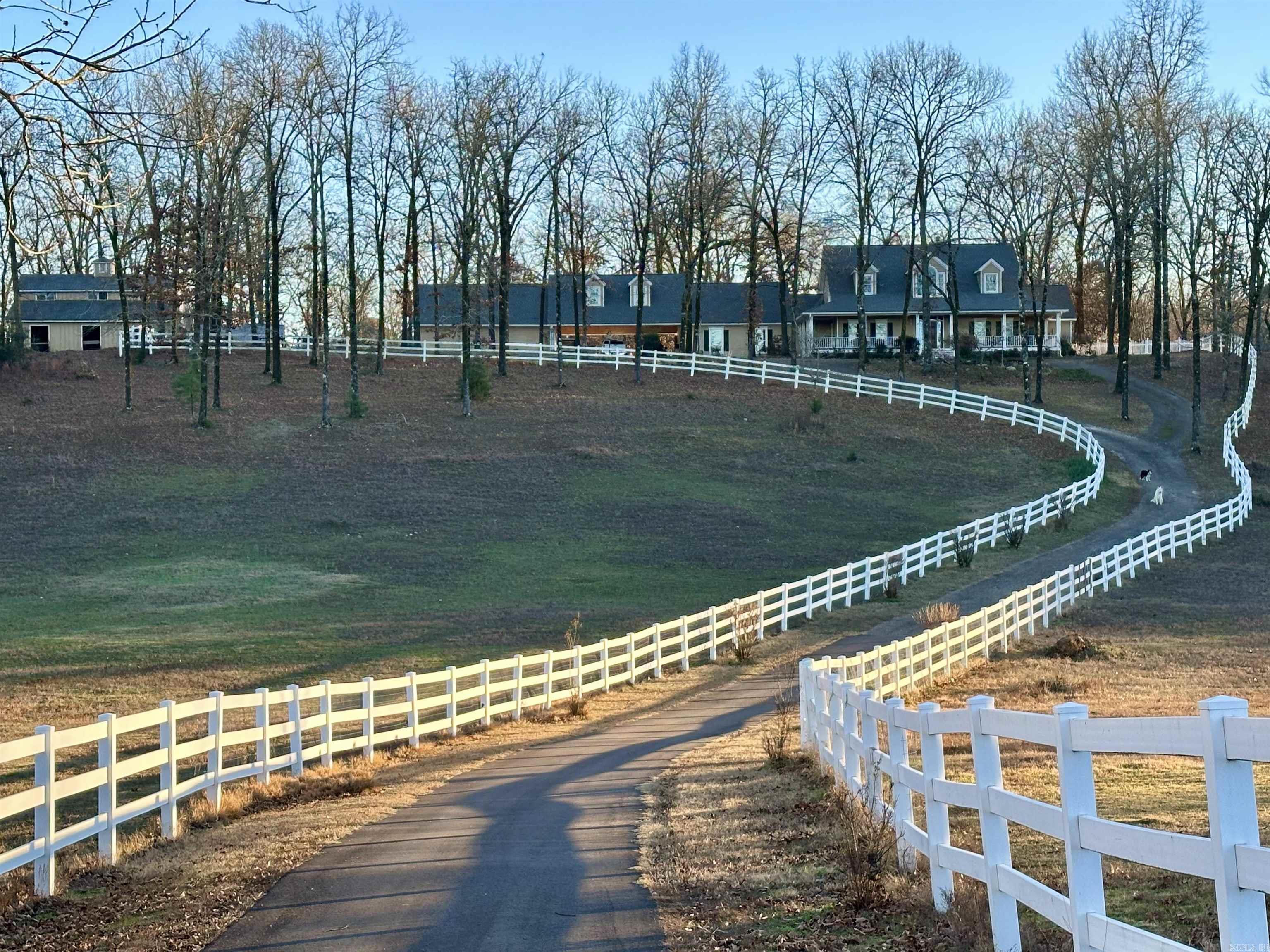 20+ FENCED ACRES, A LOVELY HOME, POOL, SHOP, BARN AND RECREATION ROOM - all less than 10 Minutes to city limits!  The driveway to this property is 1/2 mile long in an extremely private setting!  Come and enjoy the view from the wrap around porches and watch wildlife, horses and evening sunsets!  Interior of the main home offers a large Living Area with crafted millwork, Anderson windows for views of the Pool in the summer and for the Winter - a cozy fireplace.  Other features include hardwood & tile flooring throughout, separate formal and casual Dining, Office/Piano Room, large main level Master Suite, and a great Kitchen and Laundry area. Included with the main home is a separate 1 Bedroom, handicap accessible Apartment with it's own entrance, kitchenette, bath and WI closet! There is also the 850 SF Rec Room - which has its own heat/air, hardwood flooring and can be used for multiple purposes - Pickle Ball, Dance, Family Gatherings, etc.  Beyond the Rec Room is a large shop with 12' overhead doors and a 5 stall horse barn w/ Loft and Tac room.