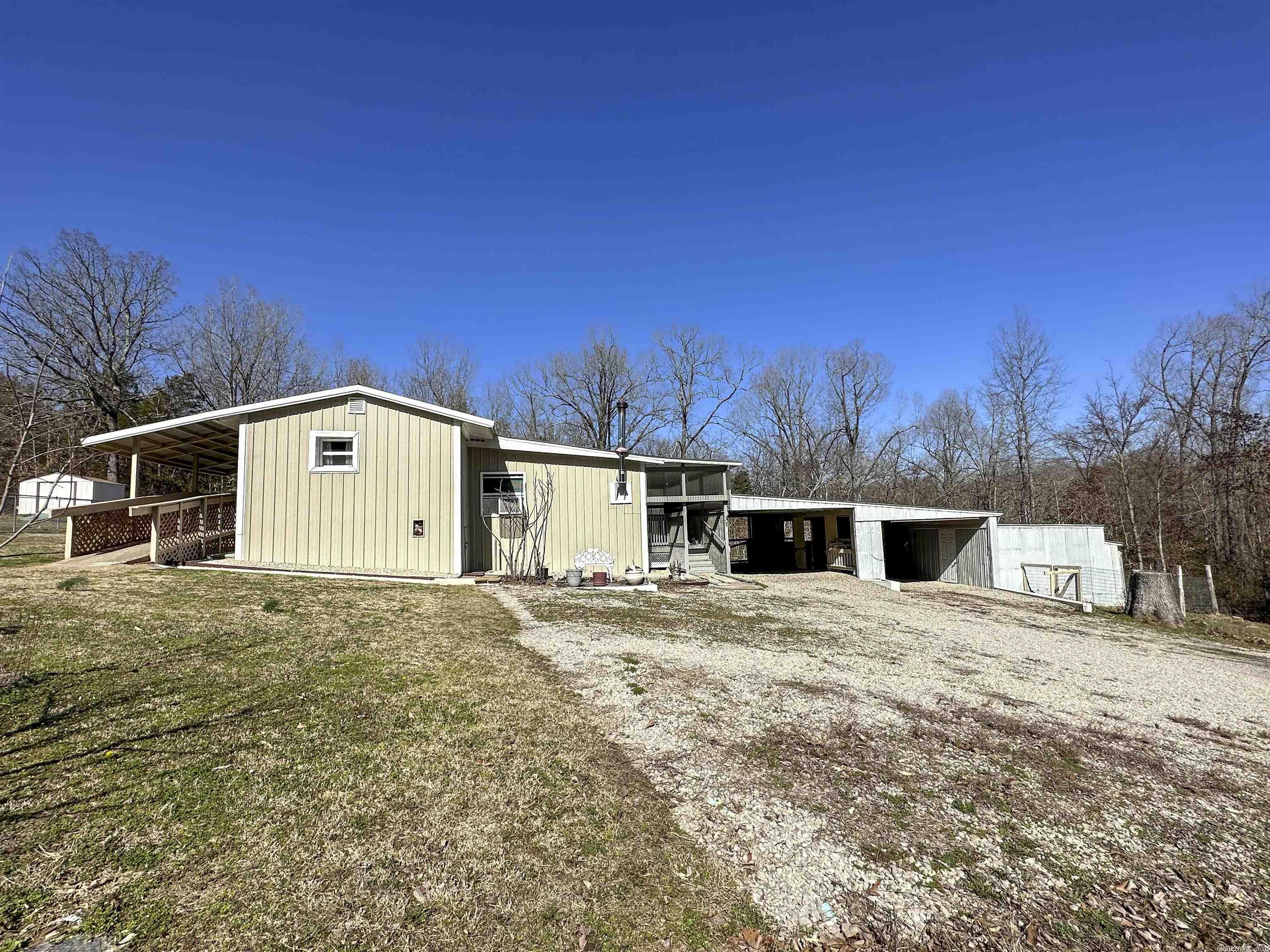 This adorable 1380 sq ft mobile home w/ addition and 2-carport is located on approx. 0.50 acre in Highland and has both city water and sewer.  With fig trees and a garden spot as well as outbuildings and fencing, this great property is perfect for those that enjoy the outdoors but don’t want or need a huge property to maintain.  From the moment you walk through the front door, you are greeted with warmth from the nice laminate flooring, coordinating wood trim and moldings, to the wood stove that heats this home with abundance.  The kitchen with tin ceiling includes all appliances.   Private master en-suite with beautiful tongue and groove wood walls.   This is a home you must see to appreciate!  Call to schedule a showing today!