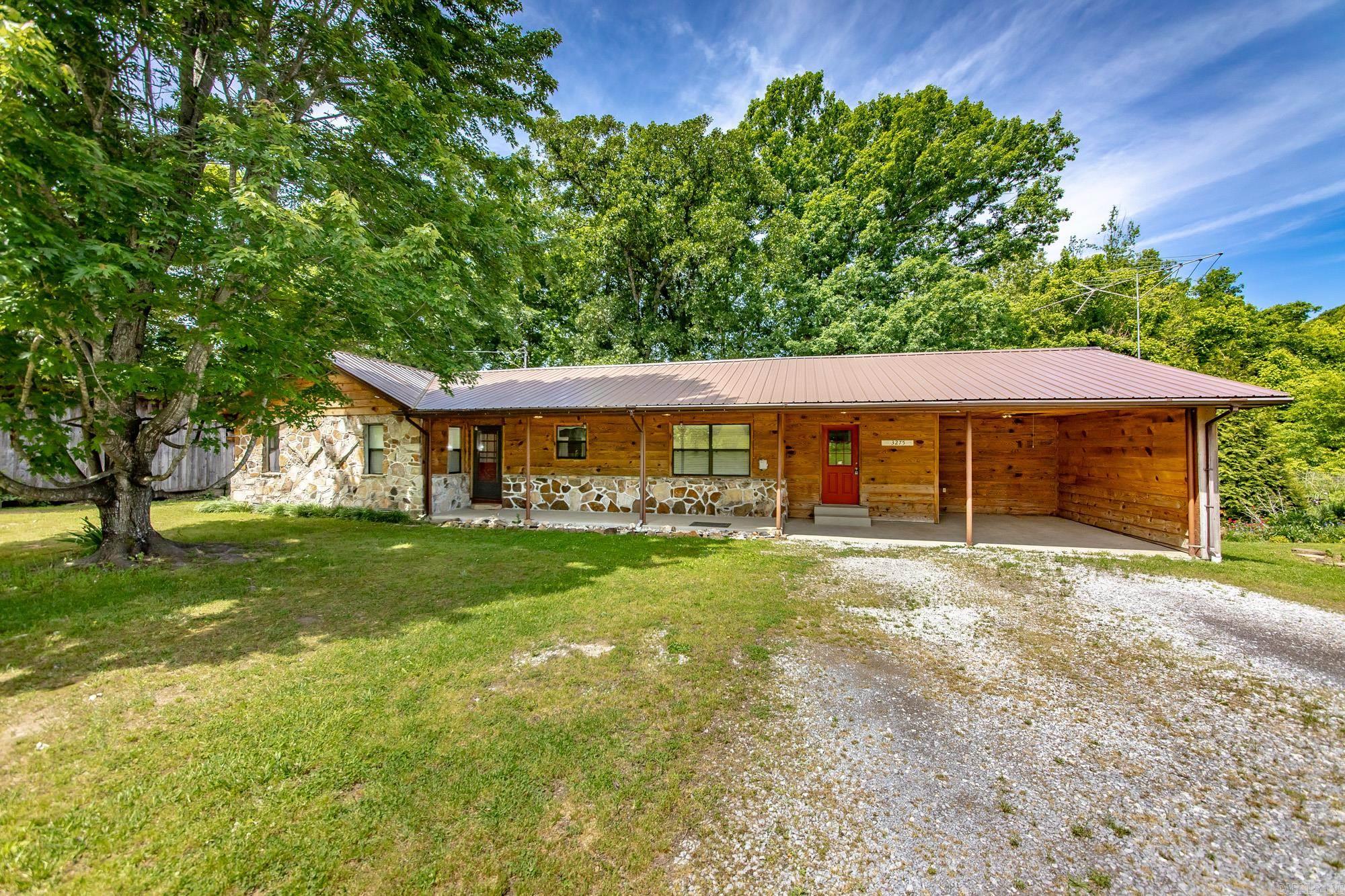 Welcome to your own private slice of country charm—where comfort, space, and character come together beautifully. This inviting 3-bedroom home sits on 1.75 picturesque acres and features stunning hardwood floors in the family room, anchored by a cozy rock fireplace with a gas stove. The kitchen is well-appointed with granite countertops, stainless steel appliances, a gas range, and a convenient breakfast bar. The spacious primary suite includes a walk-in shower, a large walk-in closet, and direct access to a covered back porch—perfect for relaxing mornings or quiet evenings. An oversized laundry room offers abundant cabinet storage and flexible space ideal for a home office or hobby area. Outside, you’ll find thoughtfully designed landscaping, blackberry bushes, and fruit trees, along with four storage buildings—including one equipped with dog pens and electricity, plus a dedicated chicken shed—making this property as functional as it is charming.