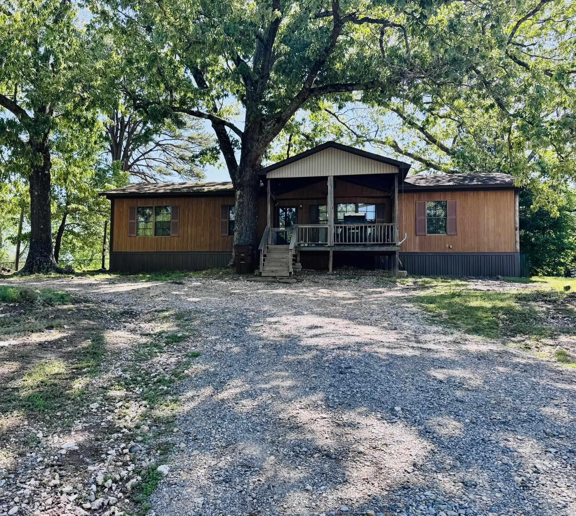 Love that small town living feel, but still want to be close to the largest lake in Arkansas? Come take a look at this double-wide on almost an acre inside the city limits of Mount Ida. This home features 3 bedrooms, 2 baths, with primary room having a walk-in shower and a very large walk-in closet. New flooring in several rooms of the home, new HVAC system, and a covered front porch that overlooks the mountains out front. Did I mention this property sits on a crystal vein? Crystals galore!