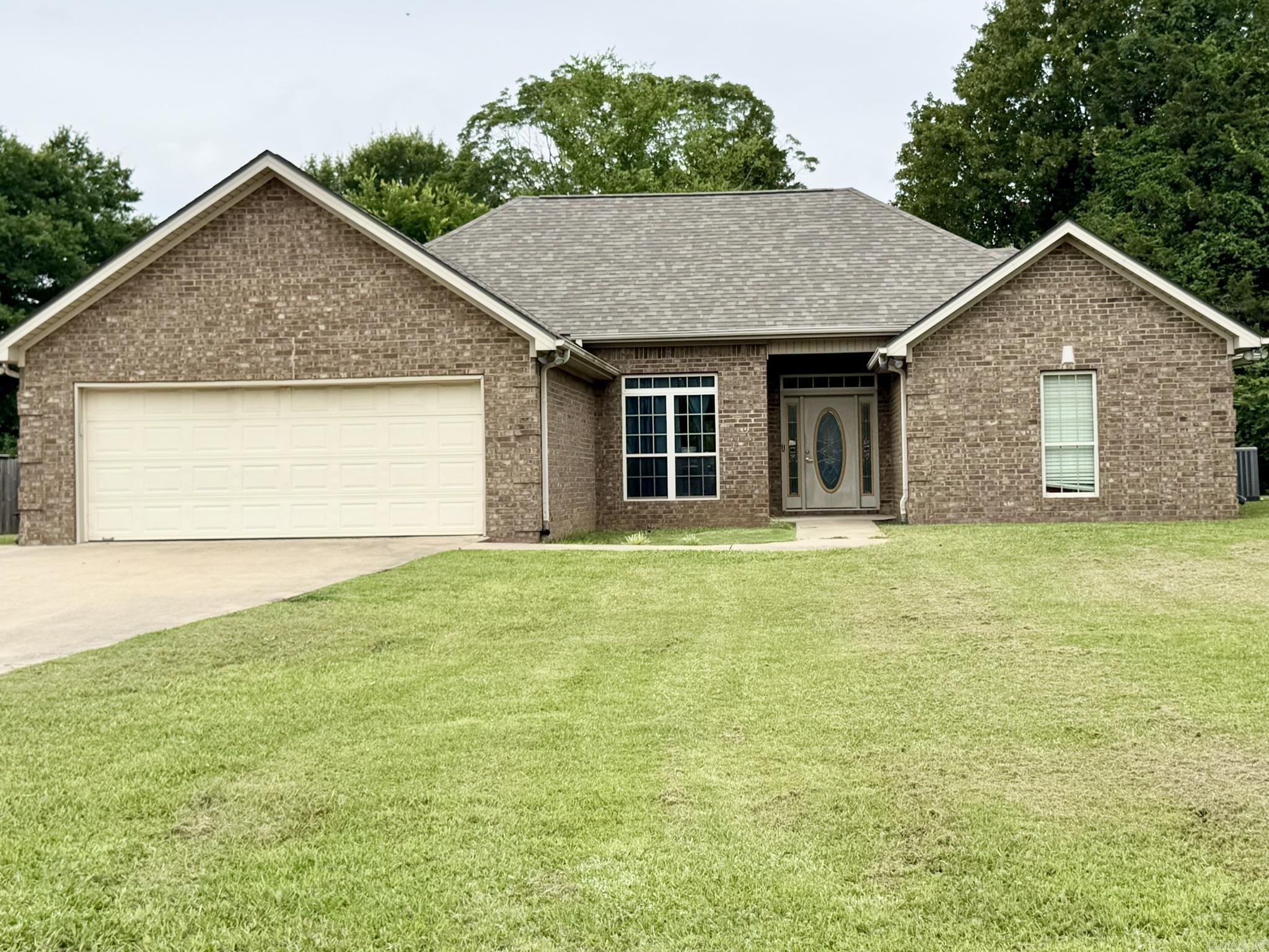 Acreage opportunity in the Cabot School District. This 4 bedroom, 2 bath brick home sits on approx. 1.41 acres in Austin and offers a comfortable one-level layout with a split bedroom plan, tall ceilings, open living/dining flow, and good natural light. The formal dining area features architectural trim, arched openings, and a welcoming connection to the entry. The kitchen opens easily to the main living area, while the dining space overlooks the backyard. Outside, enjoy a spacious fenced yard, mature trees, patio area, and room to breathe without the tight subdivision feel. The extended driveway pad offers added parking flexibility, with extra space to the left for items such as a boat, trailer, or additional vehicle. A practical home with space, privacy, and room to make it your own.