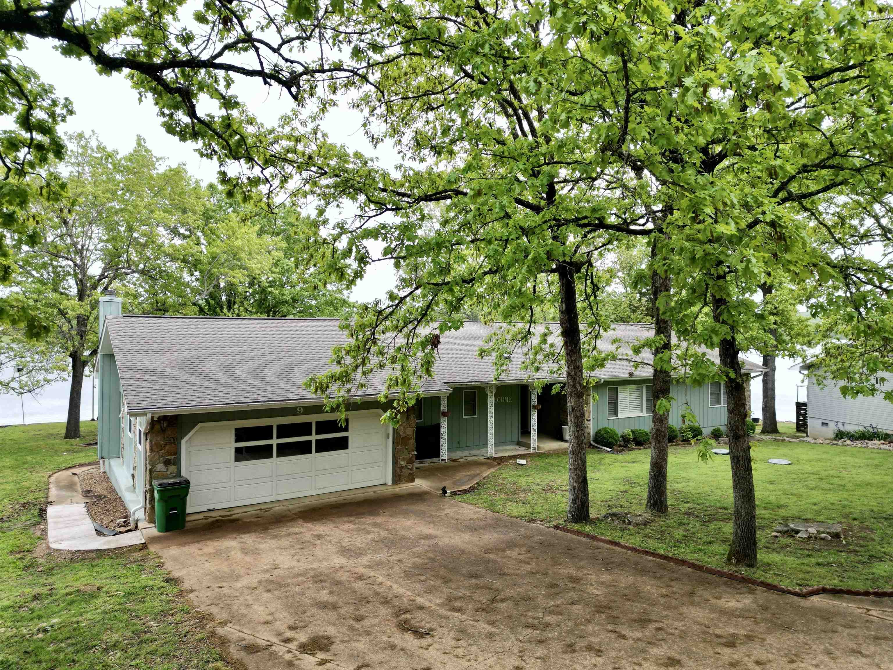 This one level well maintained and furnished  Lake Omaha home is loaded with features: 4 bedrooms, 3 bathrooms, semi-open floor plan, fireplace in the living room & a wood burning stove in the family room. Lots of windows provide a panoramic view of the lake. The main en-suite features both a shower and jetted tub. The utility room,  just off the kitchen,  has the washer, dryer, water heater, water softener and pantry. For enjoying the out of doors, a deck stretches across the back of the house with ample room for dining, cooking on the bbq or just swinging in a hammock. The 6-person hot tub is in full working order. There is a concrete seawall with a boat ramp for easy access to the lake.  The covered boat dock has 2 walkways from the seawall. An attached 2 car garage has extra room and cabinets for storage and a small workshop area. The shed provides storage for yard equipment, outdoor toys. Extra features-Ring camera installed, new roof 2022.