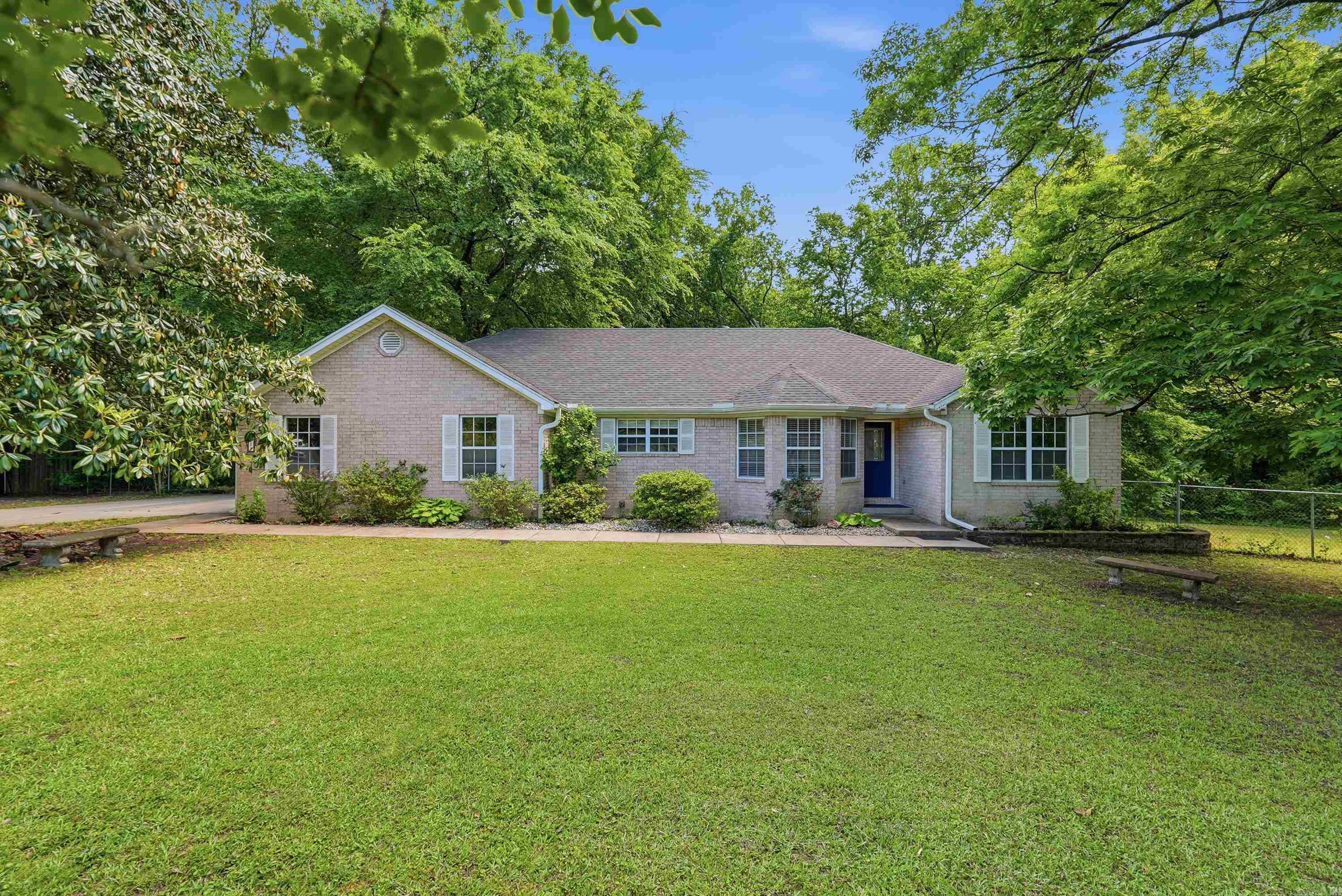 Welcome to your private home oasis of 2.65 acres tucked away at the end of a secluded drive shared with only one other neighbor. This beautiful 3-bedroom, 2-bathroom Benton home offers the perfect blend of peace and modern style. The entire interior is move-in ready and just updated, featuring brand-new paint, contemporary fixtures, and luxury vinyl tile (LVT) flooring that flows seamlessly throughout the layout. The home boasts tray ceilings and a cozy gas fireplace that anchors the main living area. The kitchen is a true standout, showcasing stunning new countertops. Thanks to the smart split floor plan, the primary suite remains a quiet retreat, separated from the additional guest rooms. There is a spacious and private wood deck overlooking the partially fenced backyard. Roof replaced in 2022. This home with easy access to all that Benton has to offer, this home feels worlds away from the hustle and bustle while keeping you connected to everything you need.