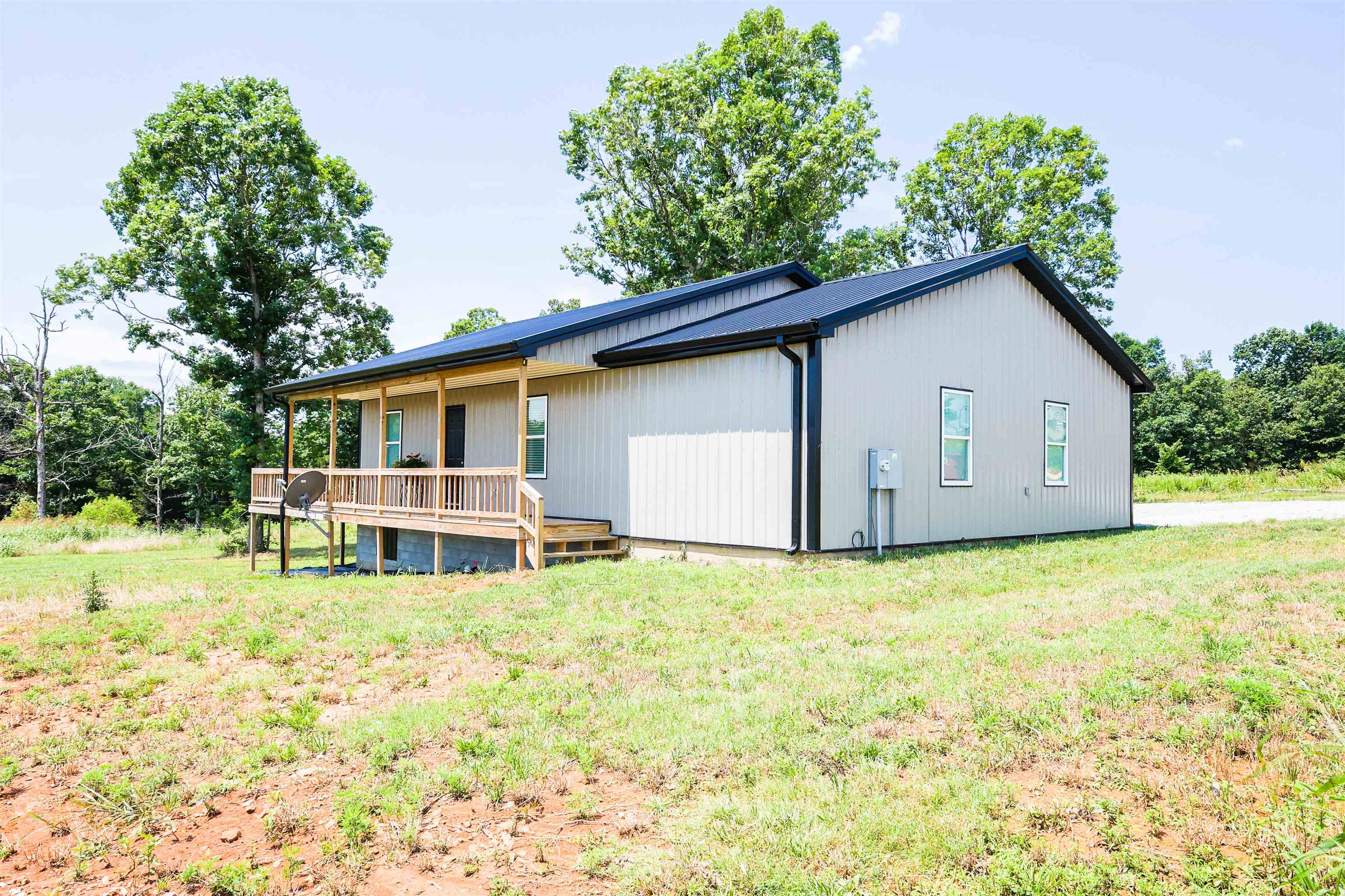 Energy-Efficient Home on 1.2 Unrestricted Acres for Sale in Melbourne, Arkansas Located at 440 Greenstreet in Melbourne, Arkansas, this 2-bedroom, 2-bathroom home was built in 2025 and offers approximately 1,155 square feet of living space on 1.2 unrestricted acres. The property also includes a 525-square-foot attached garage and is situated in a rural setting. The home features an open-concept floor plan with a pine vaulted ceiling in the living area. The kitchen includes ample cabinet space, a breakfast bar, and an open layout connecting the kitchen, dining, and living spaces. The primary bedroom includes a walk-in closet and private full bathroom. A second bedroom and full bathroom provide additional living space. Other interior features include a dedicated laundry room, central heat and air, spray foam insulation, and energy-efficient construction. Exterior features include a covered front porch, back patio, attached garage, and open acreage. The property has no restrictions and is accessed by a short gravel road. This Melbourne, Arkansas property offers newer construction, unrestricted acreage, and energy-efficient features. Offered at $179,000.