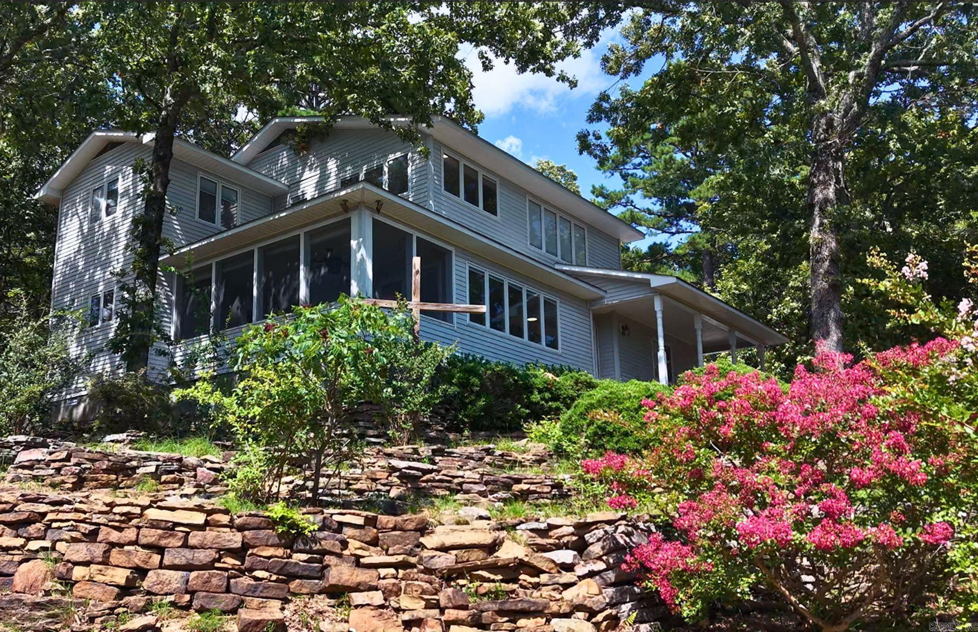 VIEW OF GREERS FERRY LAKE & SUGAR LOAF MOUNTAIN This home has 5 bedrooms, 3 full bathrooms and a 3 Car Garage. The bonus room has a view, but my favorite view is from the large, screened porch on the first level.  Bring your Side-by-Side and lake toys, because this one is ready for a new owner. Enjoy the Cool Pool, rent a boat at the Marina or enjoy the bowling alley on the rainy days. Theres lots of option for fun in the Bay.