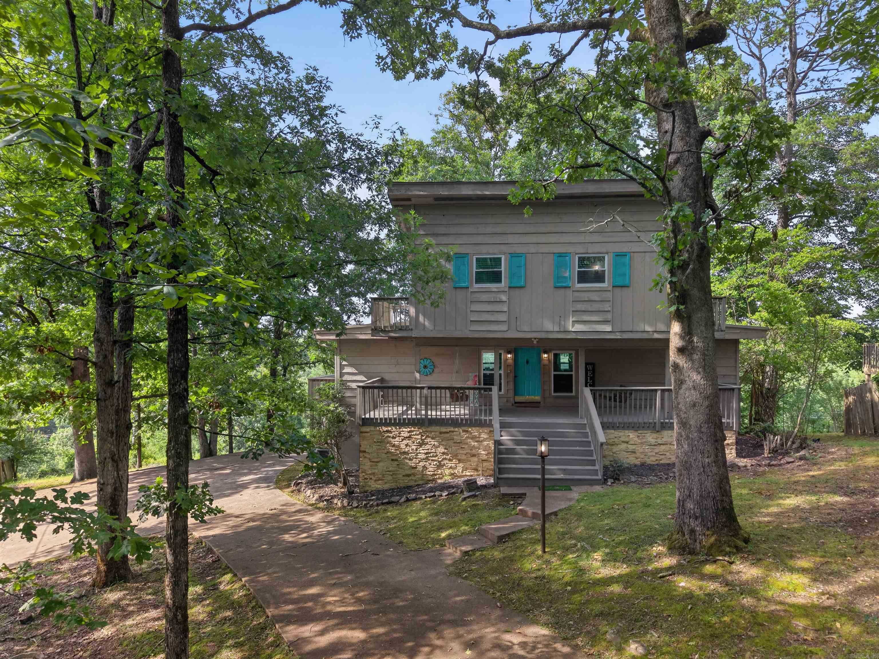 Searching for a property that offers both an exceptional lifestyle and proven income potential? This versatile 5-bedroom, 4-bath home is an ideal choice for a growing family, family retreat, vacation retreat, or short-term rental investment. Previously operated as a successful STR, it offers immediate earning potential and long-term flexibility as a vacation rental. The thoughtfully designed layout features generous gathering spaces, dramatic architectural details, and windows that frame incredible water views of the lake and mountain scenery. Recent improvements throughout the home add style and functionality, creating a move-in-ready experience. Outside, enjoy a private spa overlooking the water, spacious outdoor living areas, and unforgettable sunsets. Residents also enjoy access to sought-after amenities of Diamondhead including golf, lake recreation, a community pool, and a playground. Whether you're searching for a lake area investment property, Airbnb opportunity, second home, or a place to create lasting memories with friends and family, this property delivers space, comfort, and a lifestyle that's hard to match.