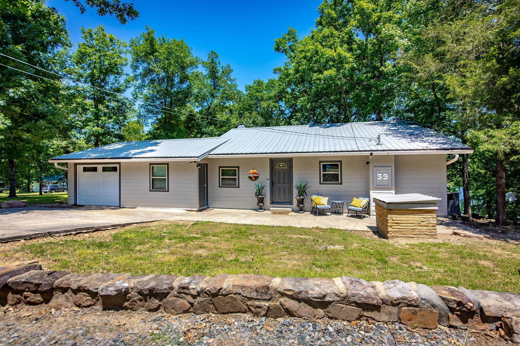 Escape to lakefront living on beautiful Greers Ferry Lake! This charming 3-bedroom, 2-bath home offers the perfect blend of comfort, relaxation, and entertainment. Ideal for hosting family and friends or simply unwinding while overlooking the water. Don't forget the boat slip, that comes with this awesome property. Inside, you’ll find a spacious layout with plenty of natural light and room to gather. The bonus room/man cave provides the perfect space for game nights, hobbies, a home theater, or additional guest accommodations. Whether you’re looking for a full-time residence, weekend getaway, or vacation investment, this lakefront property delivers the ultimate Greers Ferry lifestyle with direct access to peaceful waterfront living. Some pictures were taken below the white line. SQFT includes downstair and bonus room, sqft measuring is encourage. Some photos and video are AI enhanced. Agents see REMARKS.