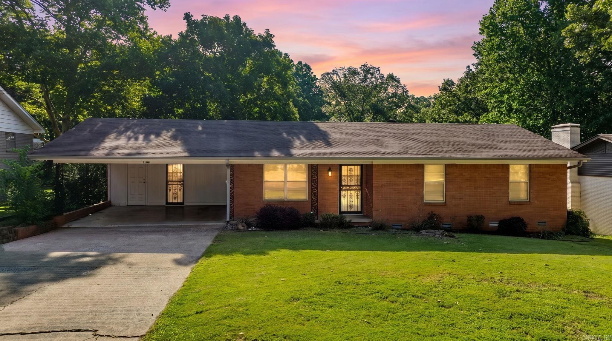 Venture over to Vine St when you'll find the kind of home that doesn't try too hard, it simply lives well. This well-cared-for midcentury ranch sits on a quarter acre lot in a quiet North Little Rock neighborhood with the kind of curb appeal that makes you slow down before you even pull in. Inside, the large open living and dining space is anchored by a stunning stone fireplace. Natural light moves through easily and the newer flooring carries you from room to room without interruption. The kitchen is generous enough to actually cook in, with room for someone perched at the counter keeping you company. Three bedrooms and two baths round out the interior, with retro tile details that lean into the era rather than away from it. Step outside and the fully fenced backyard delivers. The large covered patio is made for the way people actually live in Arkansas: slow weekend mornings, outdoor dinners, and neighbors who stay longer than they planned. A new roof and newer HVAC mean the big work is already done. Priced to sell, this wonderful home is ready for you and your next chapter.
