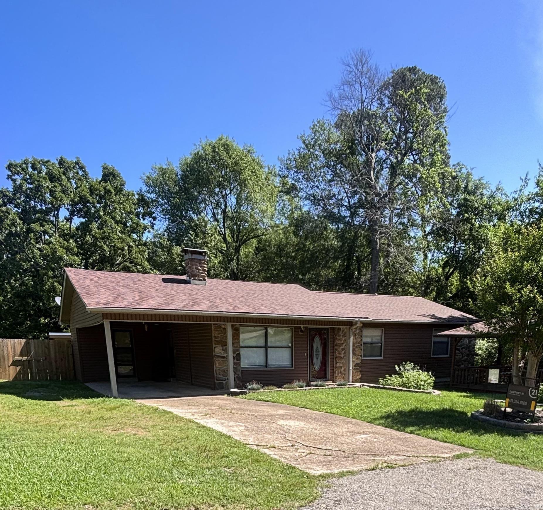Classic charm! Lovely well-maintained 3 bedroom, 2 bath home, sits on .44 acres inside city limits. The home features new quartz counter-tops in the kitchen and coffee bar area, stainless steel appliances, new paint throughout the house, new heat and air system, new vinyl siding, new roof in 2025, large den and living room, has a nice cozy fireplace. Backyard features a privacy wood fence with a concrete floor shop and storage building. Large wooded lot next door with a wet weather creek provides so much privacy. Gazebo out front with porch swing to sit and enjoy the lovely landscaping of flowers and shrubs that draw beautiful butterflies. Come check out this wonderful place!
