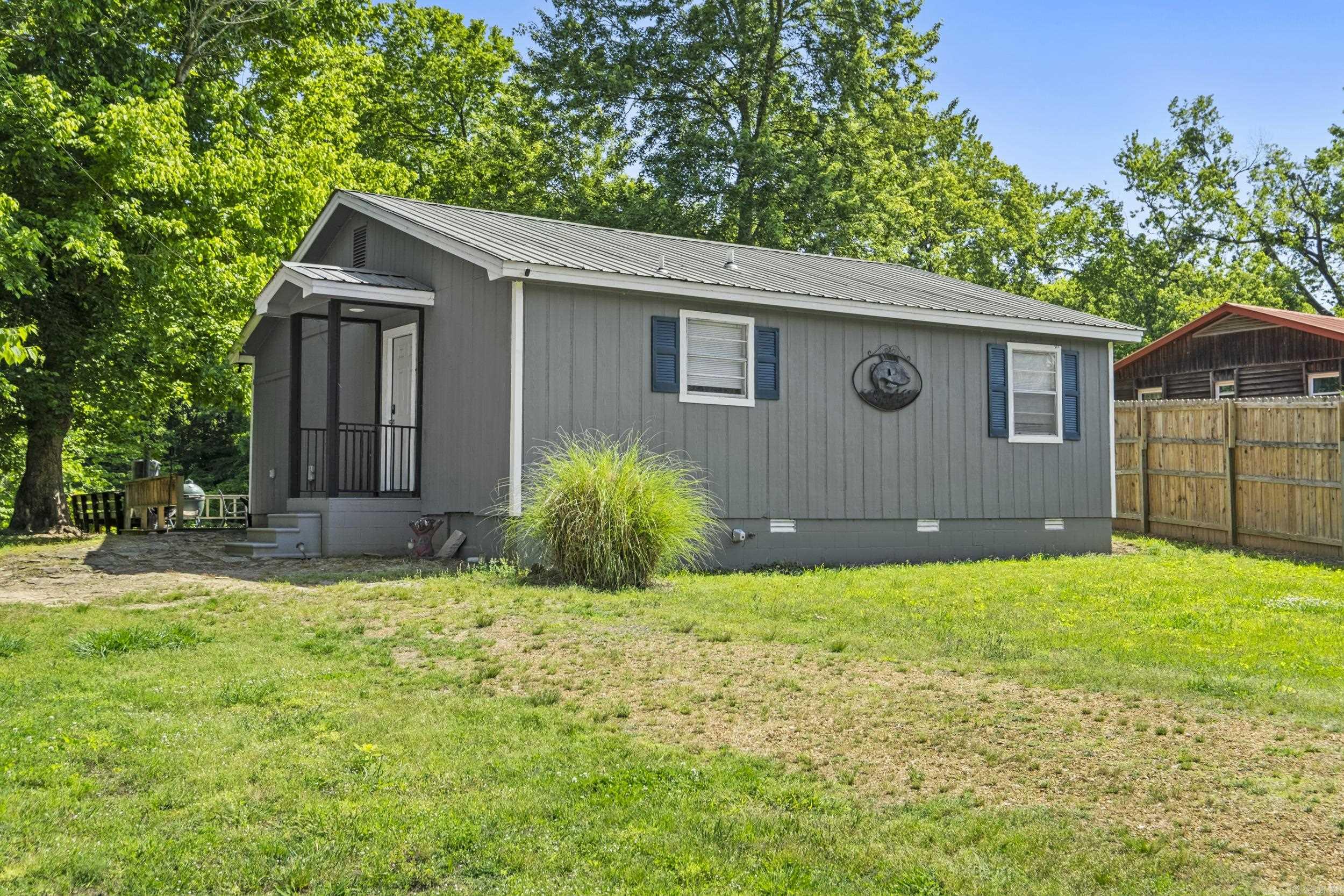 Nestled along the serene banks of the Little Red River, this beautifully remodeled 2-bedroom, 2-bath cabin offers the perfect blend of comfort, charm, and waterfront living. Completely renovated just two years ago, the home was expanded to add additional square footage while maintaining its cozy cottage appeal.Large windows span the entire back of the home, filling the living spaces with natural light and offering breathtaking river views. Step outside onto the spacious deck, where a private walkway leads directly to your personally owned boat dock — ideal for fishing, relaxing, or enjoying life on the water. Known for world-class trout fishing, the Little Red River provides an outdoor experience second to none. After a day on the river, unwind in the brand-new hot tub installed in April 2026, where you can soak in the peaceful surroundings and watch nature unfold from your own private spa retreat. Whether you're looking for a full-time residence or a vacation getaway property, this riverfront gem delivers tranquility, recreation, and unforgettable views in every season.  Property being sold with most all the furnishings.