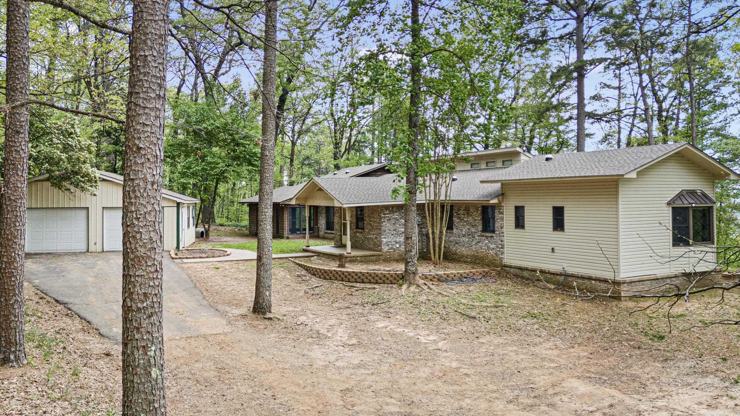 Nature Lover’s Retreat – Private Homestead Minutes from Town Tucked away on a secluded country road just minutes from town, this one-of-a-kind rural sanctuary is a dream come true for nature lovers, homesteaders, and anyone seeking serenity. Thoughtfully designed with a smoky, moody aesthetic, this near self-sufficient home offers the perfect blend of modern comforts and off-grid living. Enjoy ultimate privacy and security with private hunting grounds, two private wells connected to a holding tank with whole-house water filtration, and a reliable backup generator. Eco-conscious features include radiant heated marble floors, tankless water heater, energy-saving solar daylight tubes, and an efficient whole-house fan—perfect for reducing your carbon footprint while staying cozy and comfortable. Adventure awaits just minutes away in the breathtaking Ozark National Forest—ideal for hiking, scenic drives, or exploring your own slice of wilderness, with the natural beauty of the area including the nearby Illinois Bayou.