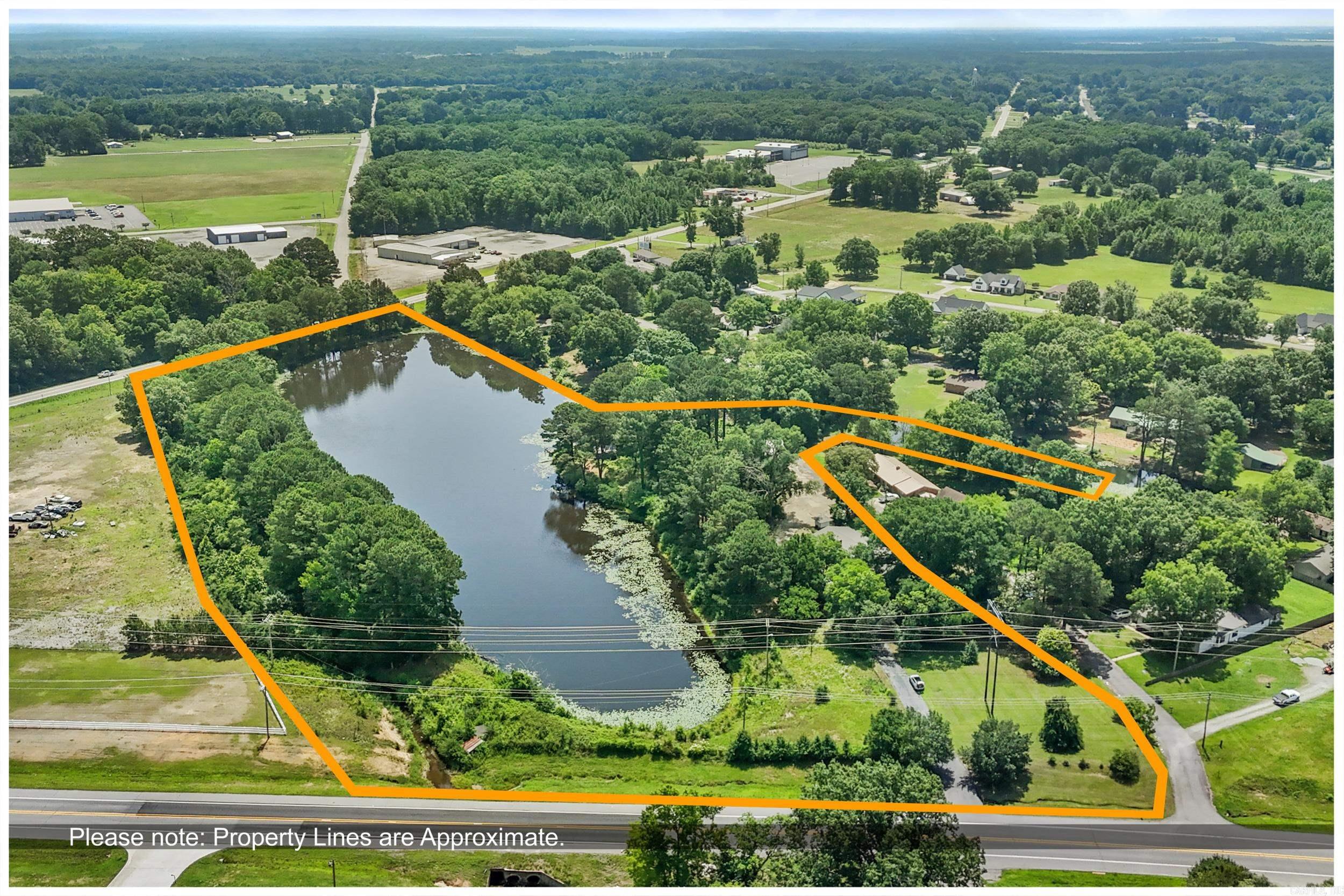 12.70 acres located just outside of Searcy city limits with your own LAKE!  This small lake has been know to provide lots of good fishing outings with some tall tells being told!  The home was built in 1960 and still holds it's vintage charm.  This home place was a place of LOTS of big family reunions with the sounds of icecream makers all around the outside.  This 3 bdrm 2.5 bath home has a huge kitchen with tons of storage.  the  bathrooms have the tile still from that era of the 60's.  This home has big bedrooms and lots of storage throughout the home.  The porch has been enclosed and makes a nice spot for those cool morning coffee breaks.  Numerous storage buildings are located at the back of the house.  There is lots of potential for this property it just needs someone with some vision.  Property is being sold "AS IS".  This is an estate and there is little information on the property.   Call before you show