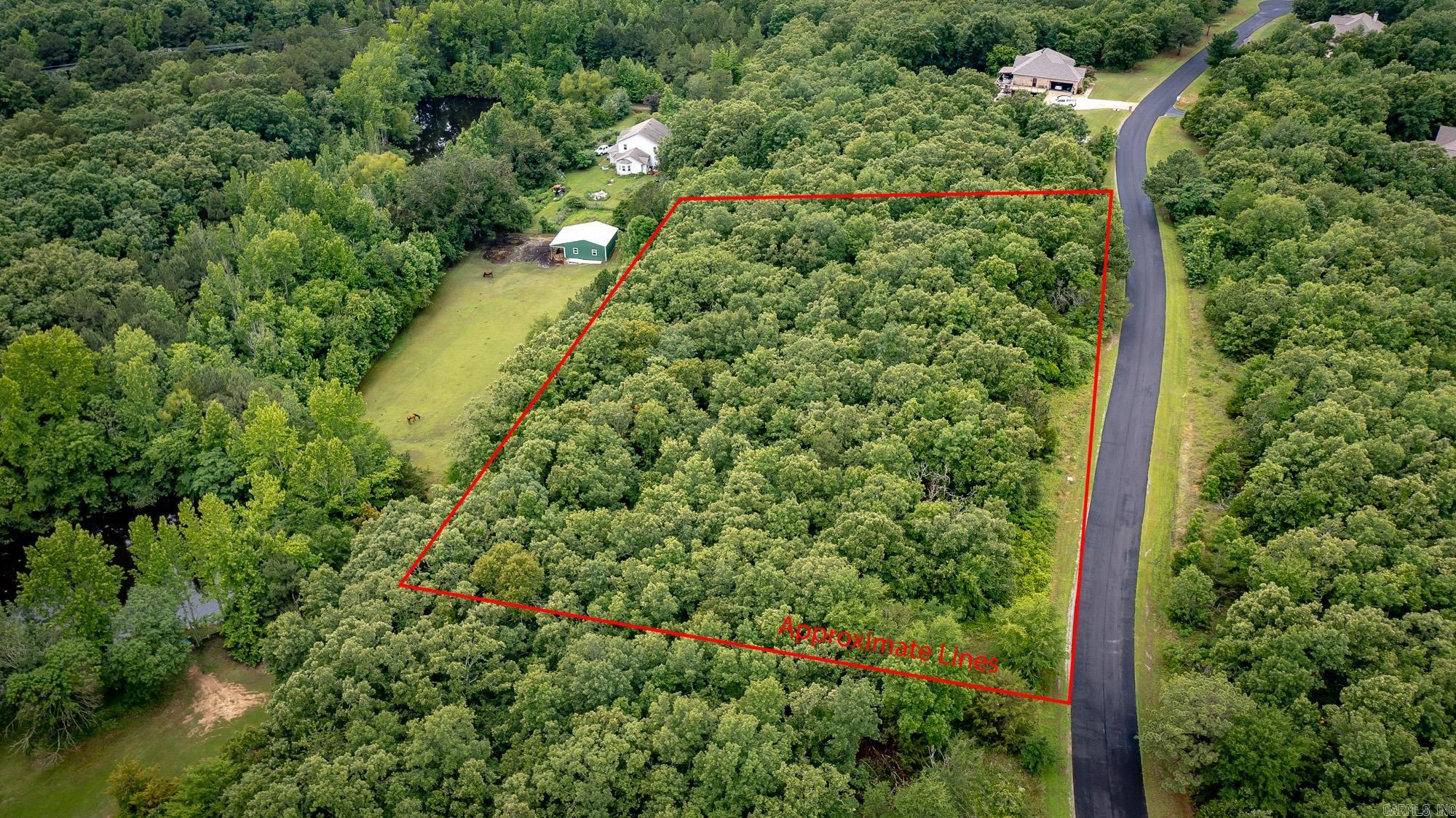 Looking for a view? Newly paved road for pleasant drive!  Beautiful wooded lot overlooking the hillside and mother nature!  This lot is perfect for a two story home, walk out basement home or garage below. Good frontage of 474 feet and goes deep 285 ft.  Look at the plat to see layout. Minimum size home is 1850 sf heated and cooled.  For this price, you can't go wrong!! Build that dream home!  Culdesac so NO through traffic!  Easy commute to freeway to Little Rock or easy drive to Conway.