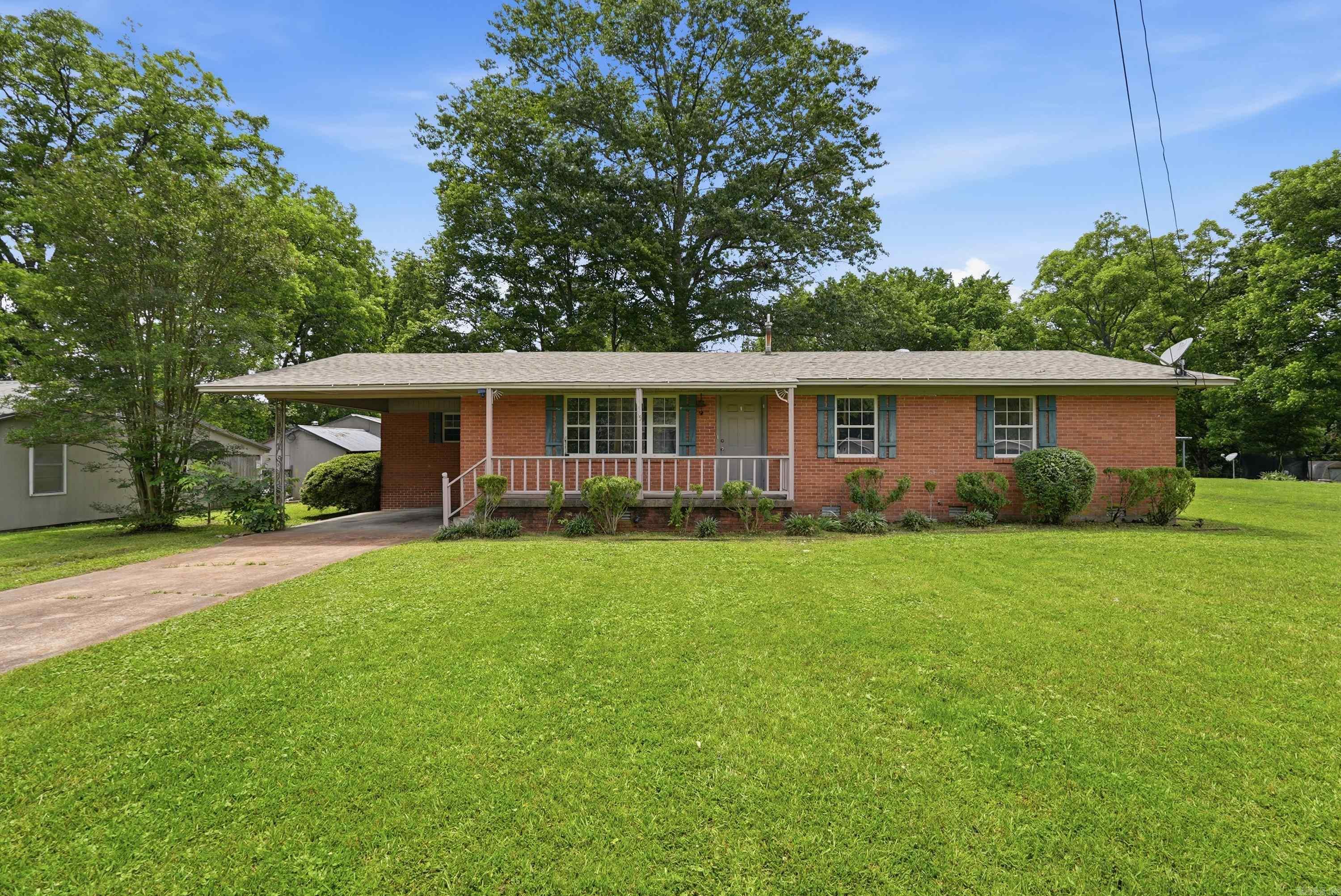 This 3-bedroom, 1.5-bath all-brick home sits on a .35-acre lot shaded by mature trees and offers a layout that feels open and comfortable from the moment you walk in. The living room and dining area flow together seamlessly, with LVP flooring running through the main living spaces; a great setup for everyday living and time spent together. The kitchen features white cabinets with ample storage, and generous counter space. Each of the three bedrooms has a ceiling fan, a good sized closet, and natural light from windows that look out onto the yard. The bathroom features white tile wainscoting, a vanity with storage, and a tub/shower combination. Outside, the yard is one of this home's best features. Mature shade trees, a back deck, and a spacious lawn give you room to make it your own.  See agent Remarks