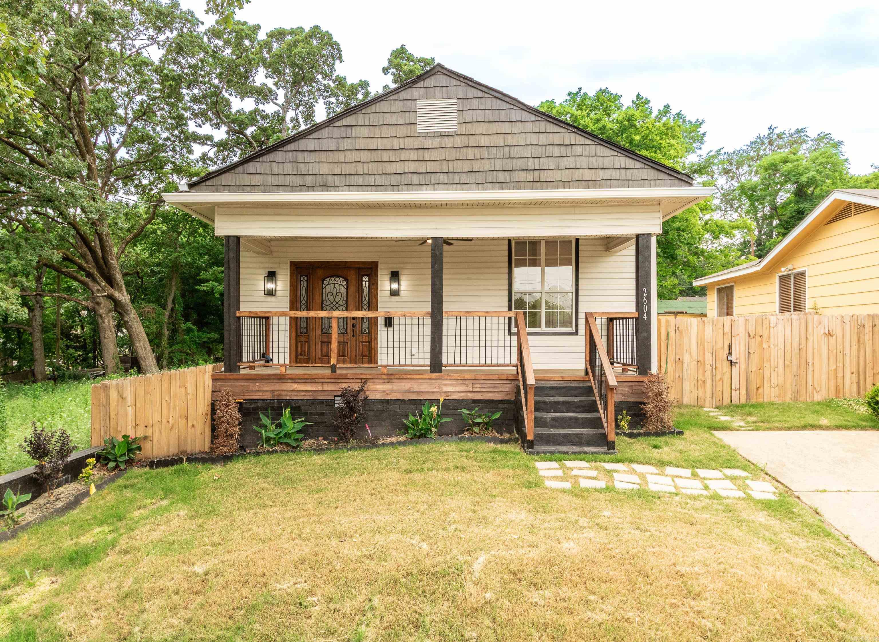 Fully renovated and move-in ready, this beautifully restored Craftsman-style home blends historic charm with modern luxury in the heart of Little Rock near the vibrant SoMa District. Taken down to the studs and rebuilt with high-end finishes, this home offers the feel of new construction while preserving its original character. Inside features an open-concept floor plan with tall ceilings, recessed lighting, luxury vinyl flooring, and an electric fireplace. The gourmet kitchen includes quartz countertops, custom white cabinetry, stainless steel appliances, over-the-range convection microwave, coffee bar area, and refrigerator that conveys.   The spacious primary suite offers a walk-in closet, spa-style bathroom with custom walk-in shower, and direct access to the oversized back deck and fully fenced backyard. Major 2025 updates include roof, windows, plumbing, electrical, water heater, gutters, fixtures, and ceiling fans. Storage building conveys. Conveniently located near downtown dining, entertainment, hospitals, and interstate access. Great primary residence or turnkey investment opportunity.