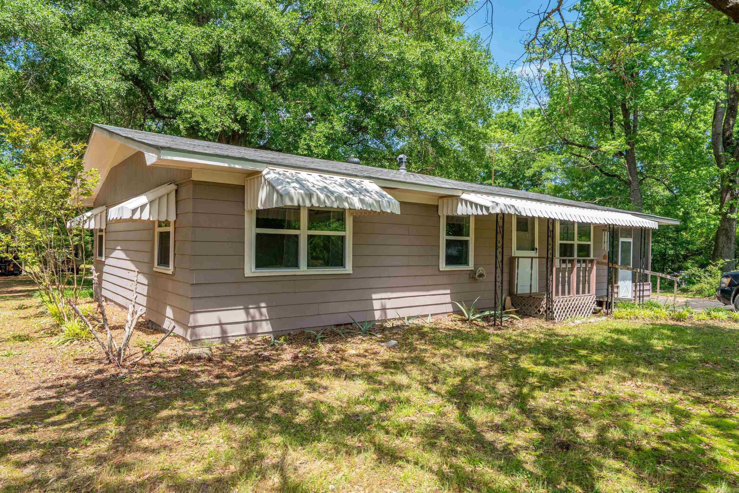 Cozy home in Gum Springs on large lot with mature trees in backyard welcoming guests! This home has 3 bedrooms, 1 full and one half bath, laundry room, white pine walls in main living area, screened side porch and back deck.  Storage/shop area.