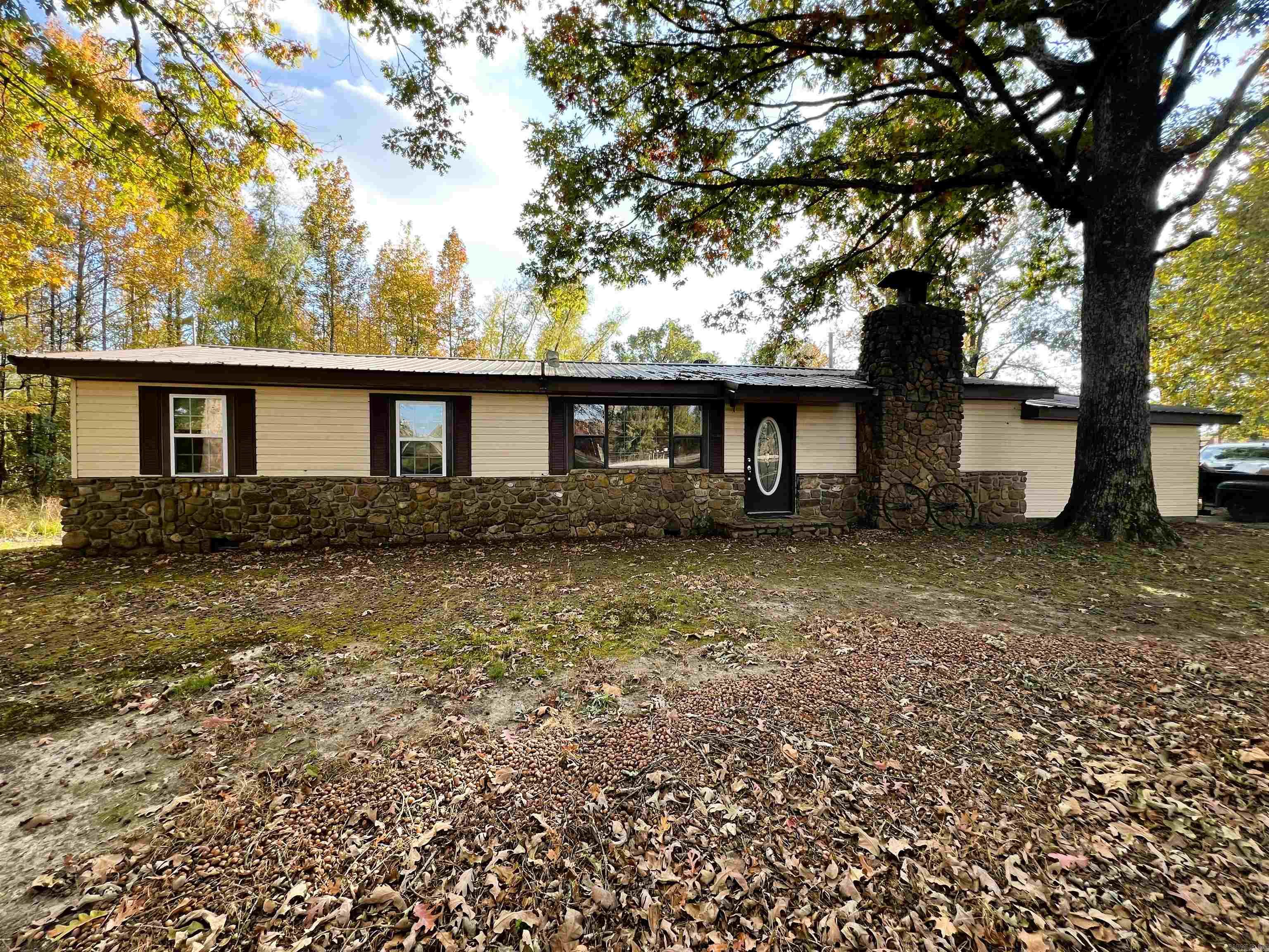 This ranch-style home is situated on 1.6 acres and located just 5 miles west of Mena on the main road, offering convenient access to the new bike trail attraction, as well as Wilhelmina Lake. It features a sunken den area with a natural rock fireplace made from locally sourced stones. The wood burning stove adds a rustic touch and serves as an alternate source of heat, ready for cold weather. On hot summer days, take a step outside onto the covered patio, where you will find the built-in pool calling for you to cool off. The pump system was replaced in 2025. The plumbing drain system in the house was replaced in 2023.
