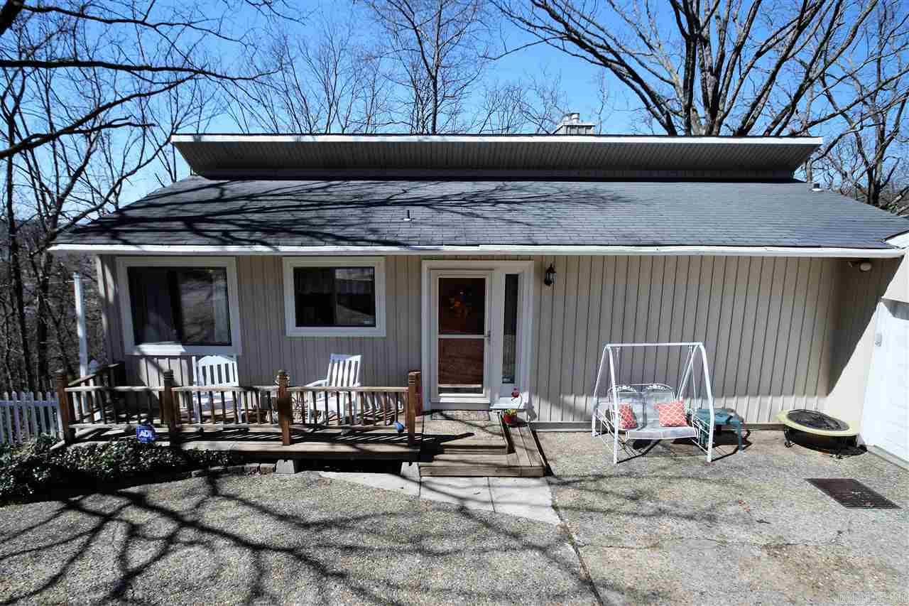 What a gorgeous home in a wonderful location. New hardwood flooring! This two story home is perfect for a growing family, easy entertaining with this floor plan, enjoy front deck, side deck or back deck with great views! Cabinet filled kitchen with eating area, large family room with fireplace and glass doors to enjoy the wooded view!  Master bedroom on main level. New windows! If you need some space this is it! Sq. Ft. approx. measuring encouraged.