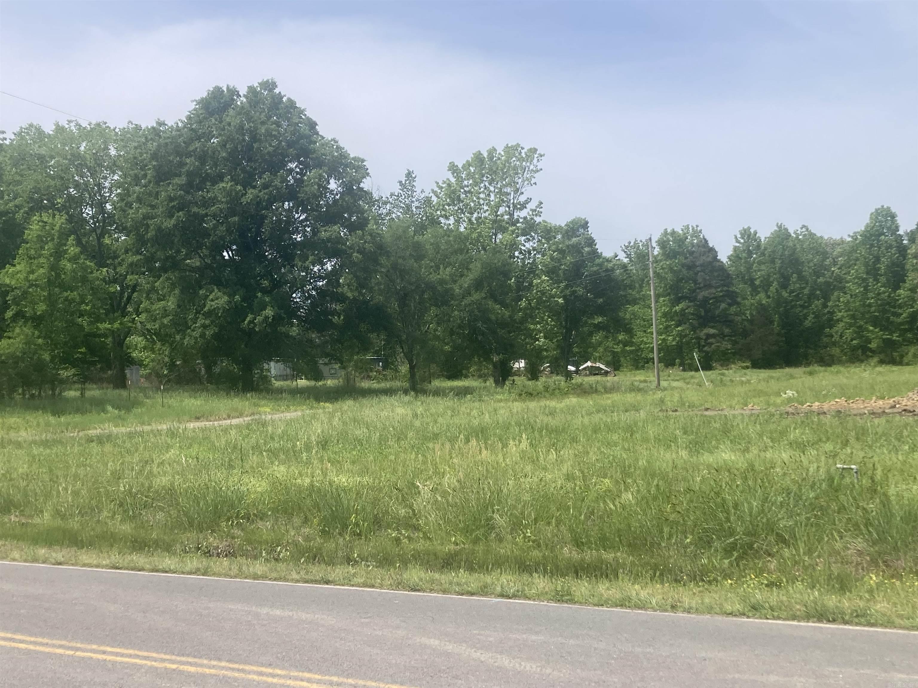 12.96 +/- acres that would be great for building a house or two and having land for horses and recreation. Convenient to Vilonia and to Hwy 64 for access to I-40, I-57 and LRAFB.  Has a creek and small pond running through it causing approximately half of the land to be in flood zone. Property IS NOT in city limits but properties on all 3 sides are in city limits so it might be eligible for annexation if buyer chooses. Church Street frontage 384 feet. Cash offer talks!
