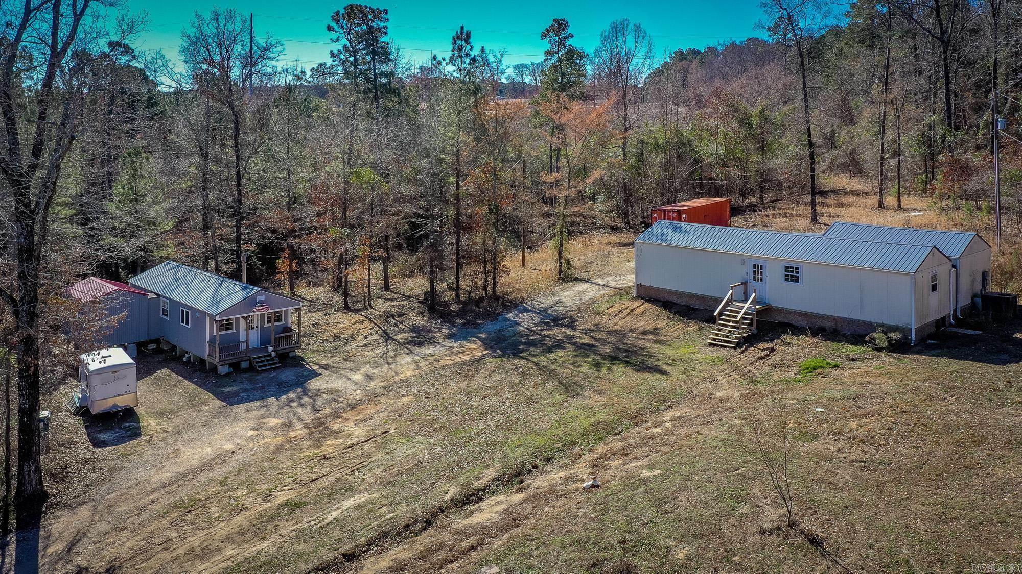 Just minutes from the Lennox Marcus boat ramp on beautiful DeGray Lake, this unique 6+ acre property offers the perfect blend of privacy, versatility and scenic charm.  Featuring two cabins, it is ideal for a weekend getaway, income-producing investment, or full-time residence. The first cabin offers approximately 920 sq ft with 2 bedrooms and 1 bath, while the second provides approximately 1,200 sq ft with 1 bedroom, 1 bath and a spacious living area.  Both cabins include their own laundry rooms for added convenience. Relax & unwind in your private hot tub, enjoy the peaceful mountain view, or take advantage of the miles of walking/ATV trails in the area. A small creek runs behind the property as well. With lake access just minutes away and room to roam, this property delivers both recreation and retreat in one incredible setting.  Price to sell, this opportunity will not last long.  Schedule your showing today.