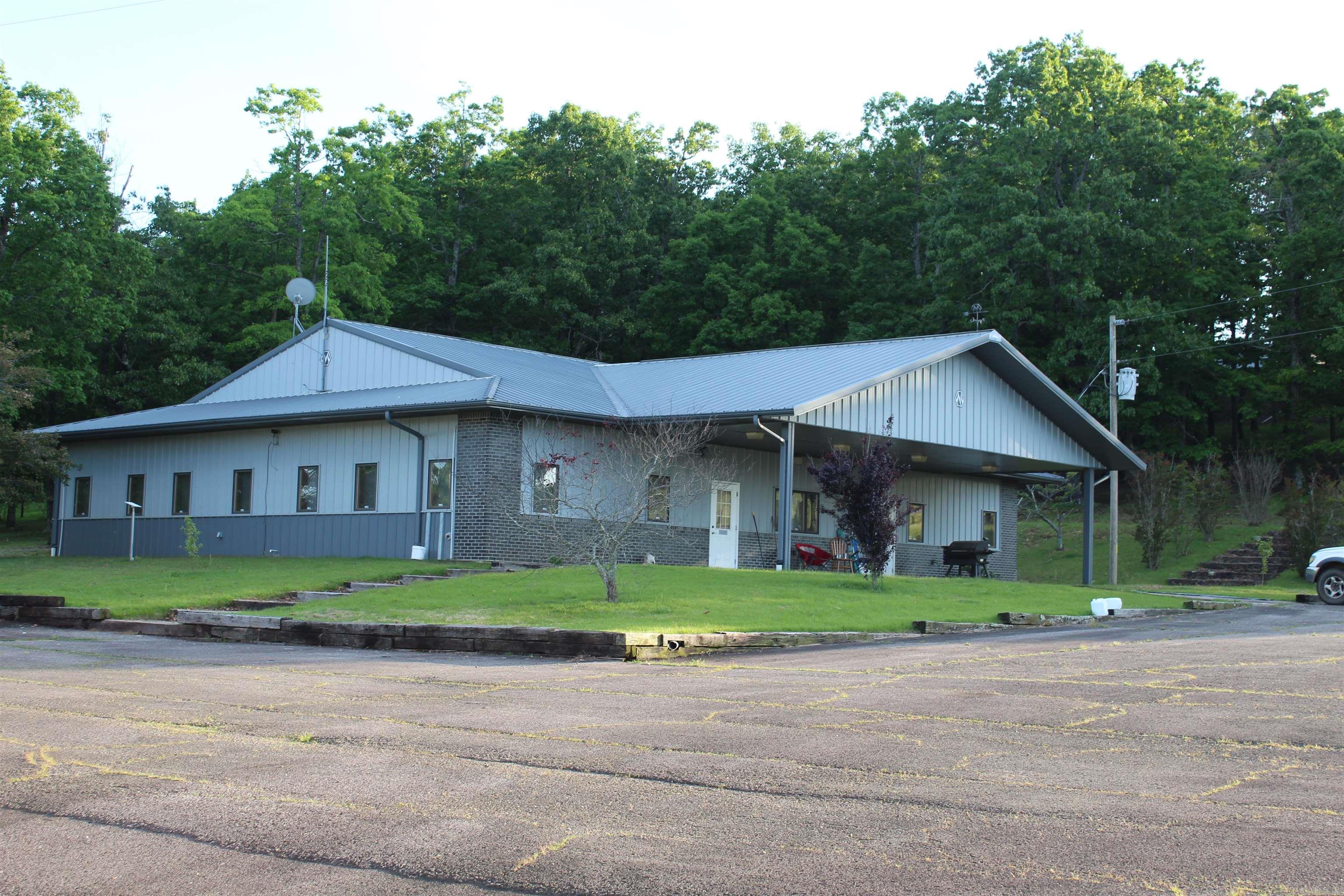 4,288 sqft Office/House, 50X90 insulated red iron shop, 2500 Sqft Insulated red iron warehouse with loading dock, 60X70 Pole Barn with electric, and several storage buildings with power. many opportunities from commercial shop, warehouse, and office space, to rental opportunities, or one sweet living compound.  no restrictions!  Highway frontage, 3 wells, multiple septic systems, city water, 3 electric meters, asphalt drive, over 8acres with plenty of room to graze your livestock or expand.  All located just minutes from the national forest.  Incredible bang for your buck on this one!