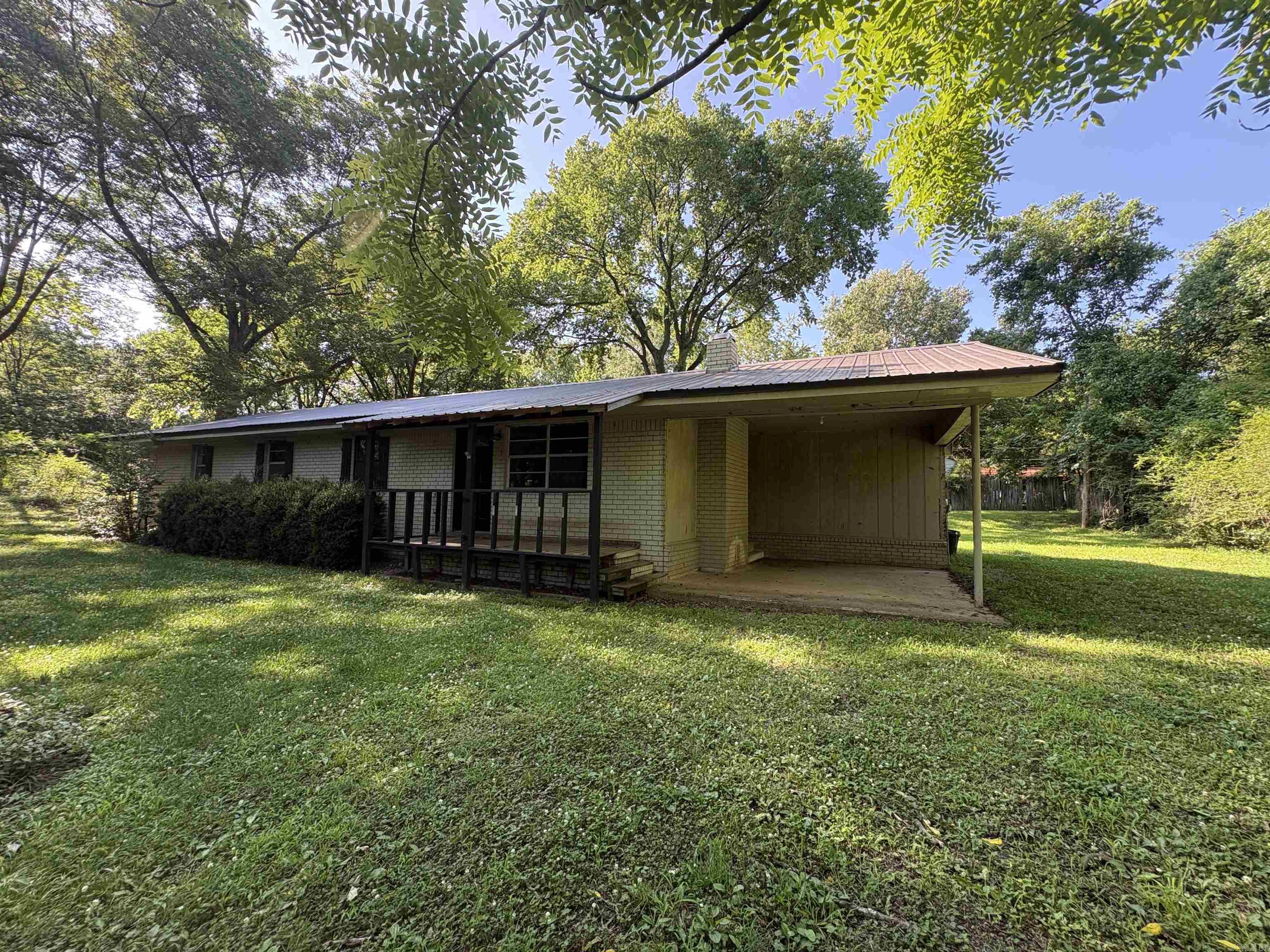 Discover your own piece of rustic paradise just outside of the city limits. This adorable home nestled on 4.13 acres offers endless potential for those seeking serenity and opportunity. Some key features are the wood burning fireplace, covered back deck area, large bedrooms, spacious laundry area and master closet! 3 wells on the property. Stove is brand new. Furnace is new. Seller is selling AS IS.