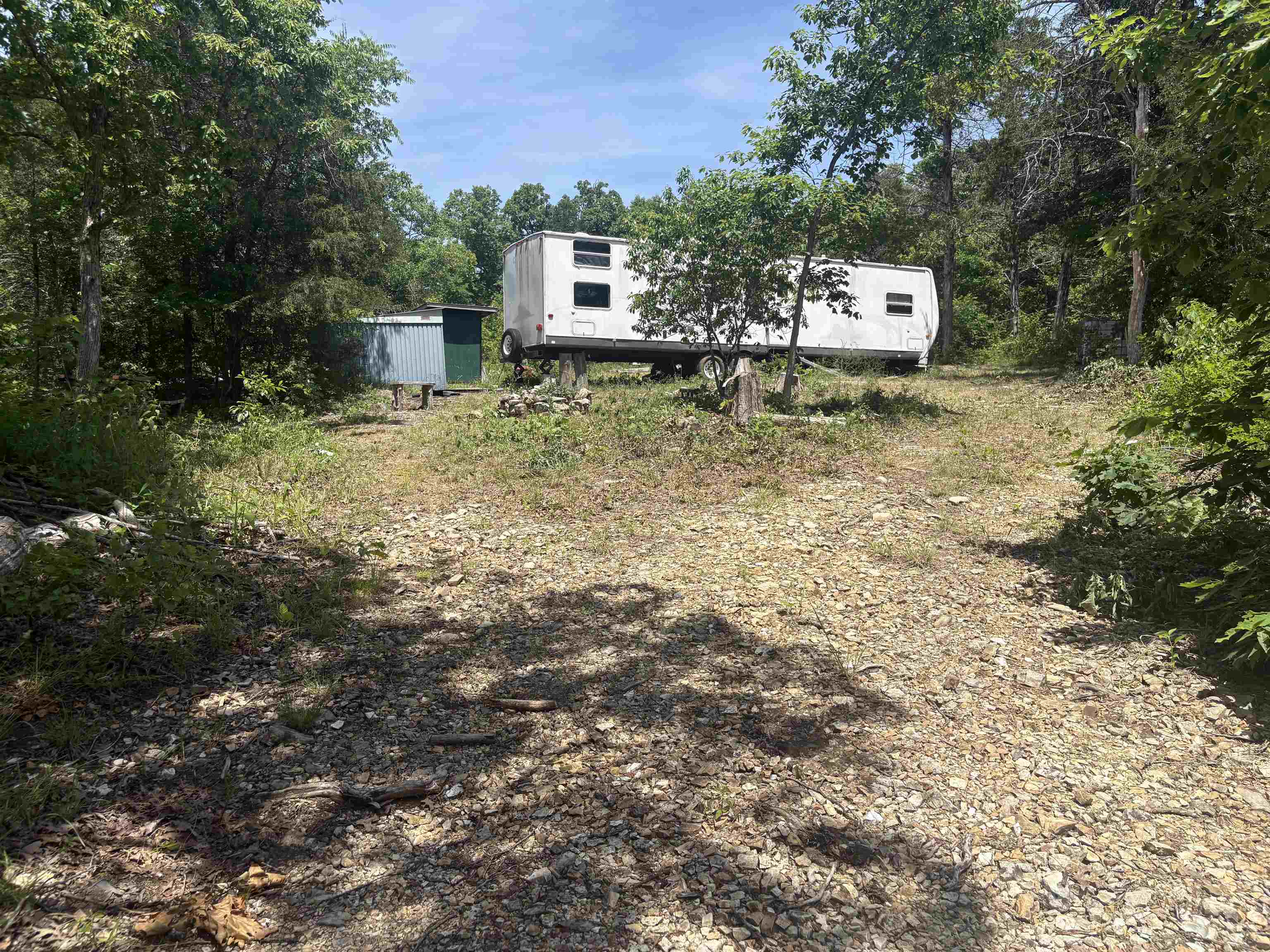 Off-grid hunting property near Harold Alexander Wildlife Management Area with camper, solar power, and wet weather creek. This hard-to-find 5-acre recreational tract in the Ozarks is geared toward hunters, outdoorsmen, and anyone looking for an off-grid escape. The property includes a camper, solar panel system, water storage tanks, fruit trees, and a wet weather creek that helps draw wildlife through the property. Surrounded by nature and abundant wildlife, this is the perfect setup for a hunting camp, survival retreat, or weekend getaway. Enjoy privacy, seclusion, and the freedom of off-grid living in the heart of the Ozarks.