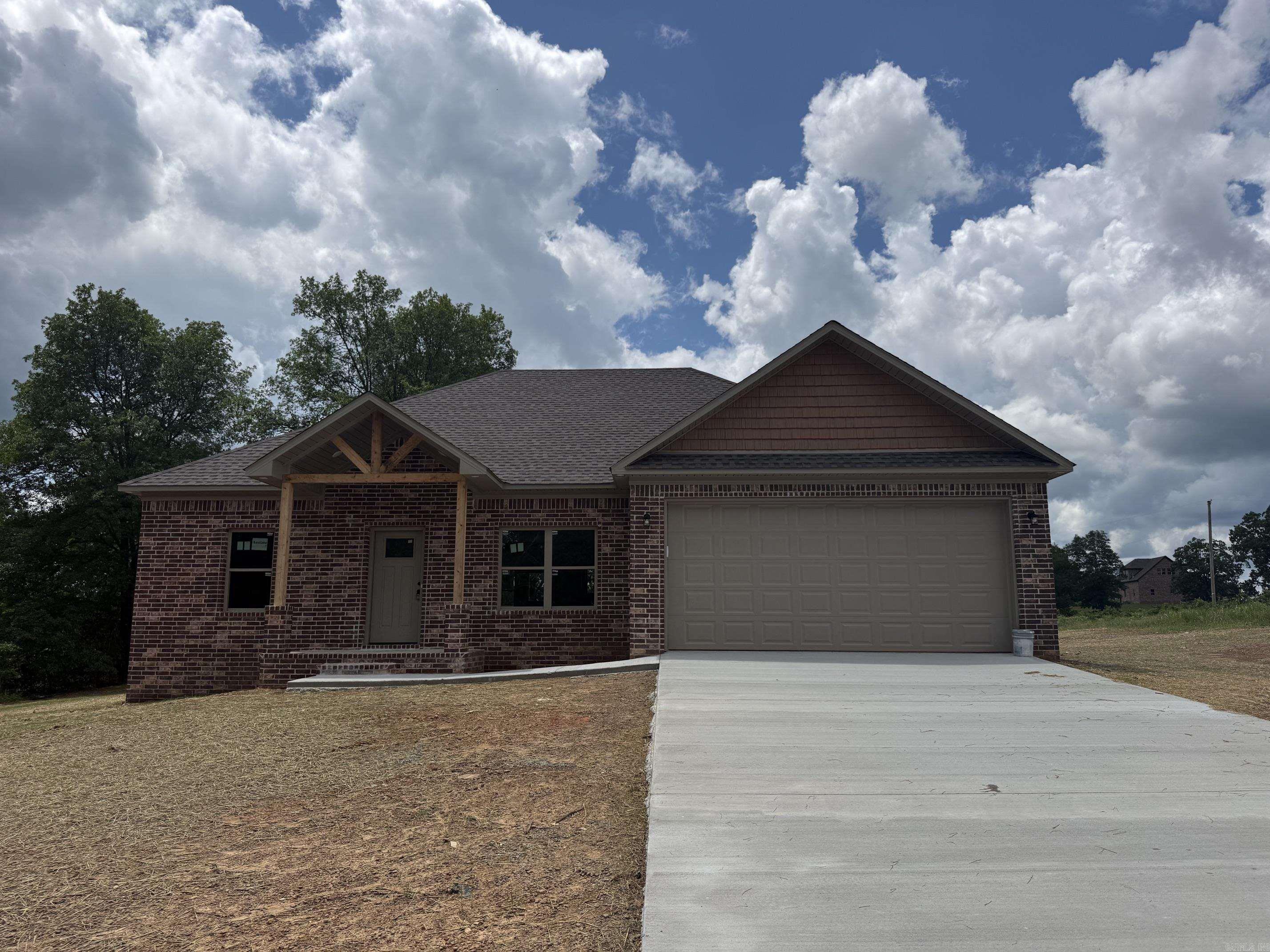Brand new construction with modern style and thoughtful design! This 3-bedroom, 2-bath home features an open-concept layout with a spacious living area, soaring vaulted ceilings, and abundant natural light. The kitchen is designed for both function and style with a large island, custom cabinetry, and ample storage space—perfect for entertaining or everyday living.  The private primary suite offers a relaxing retreat with a double vanity and a walk-in shower. Secondary bedrooms are generously sized with easy access to a full guest bath. Quality finishes throughout include recessed lighting, clean lines, and a neutral color palette.  Enjoy the durability of a full brick exterior, a 2-car garage, and a peaceful setting with room to spread out. Don’t miss this chance to own a beautiful new home soon to be completed!