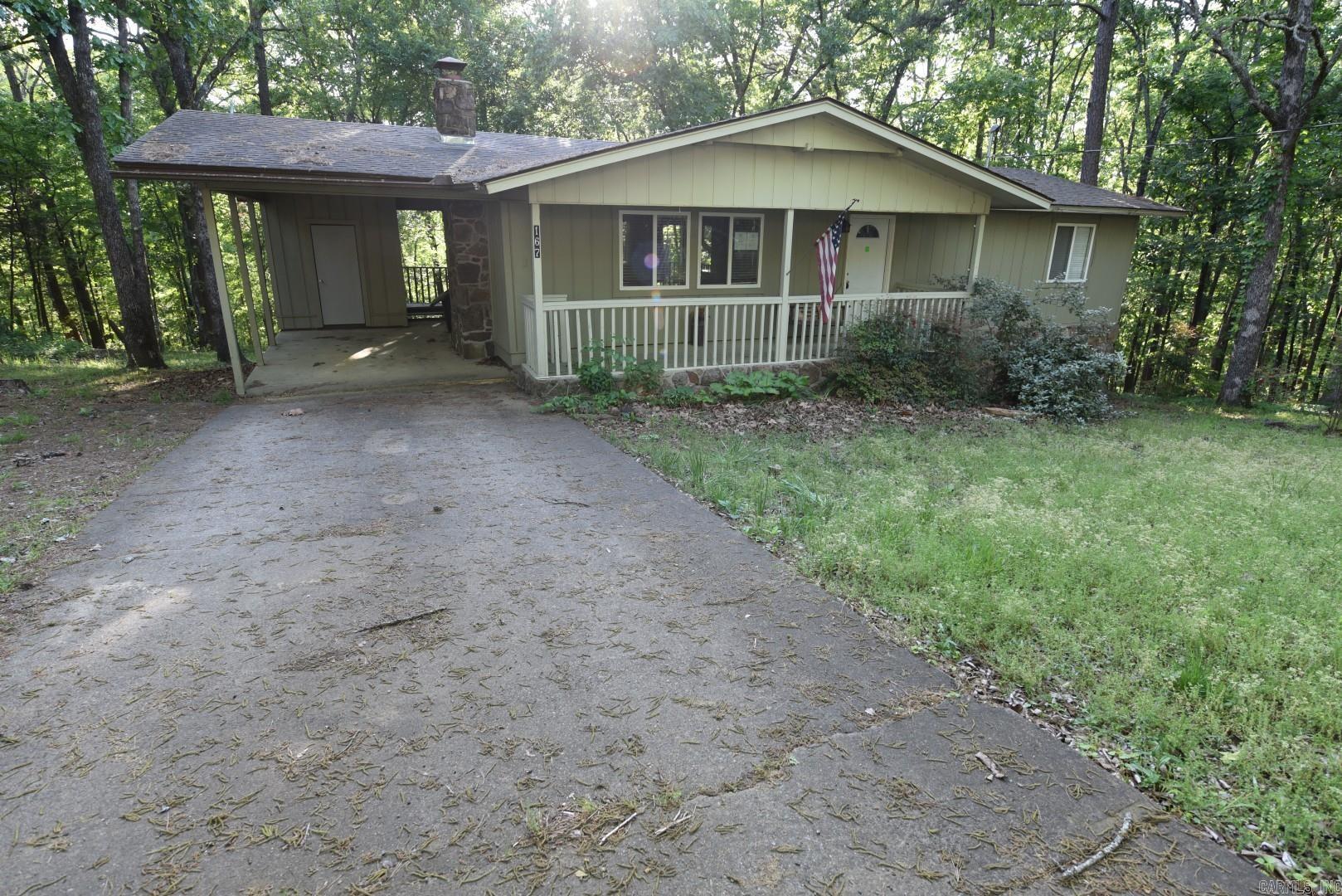 Great opportunity to own a charming home in the heart of Fairfield Bay, Arkansas! This well-maintained property offers a comfortable open floor plan perfect for relaxing or entertaining. Enjoy cozy evenings by the beautiful stone fireplace with gas logs, while large windows bring in natural light and showcase the peaceful surroundings. Step outside to a spacious deck overlooking the woods, providing excellent privacy, or unwind on the inviting front porch located on a quiet street. This home has seen numerous updates, including newer windows, roof, HVAC system, and refreshed cabinetry, giving you peace of mind and modern touches throughout. Conveniently located just a few miles from the Fairfield Bay Marina and boat launch, making lake days easy and accessible. Fairfield Bay offers an abundance of amenities including hiking and biking trails, ATV trails, three swimming pools, miniature golf, pickleball and tennis courts, bowling, and multiple golf courses. Enjoy the charm of small-town shopping and a relaxed lifestyle in this scenic community.
