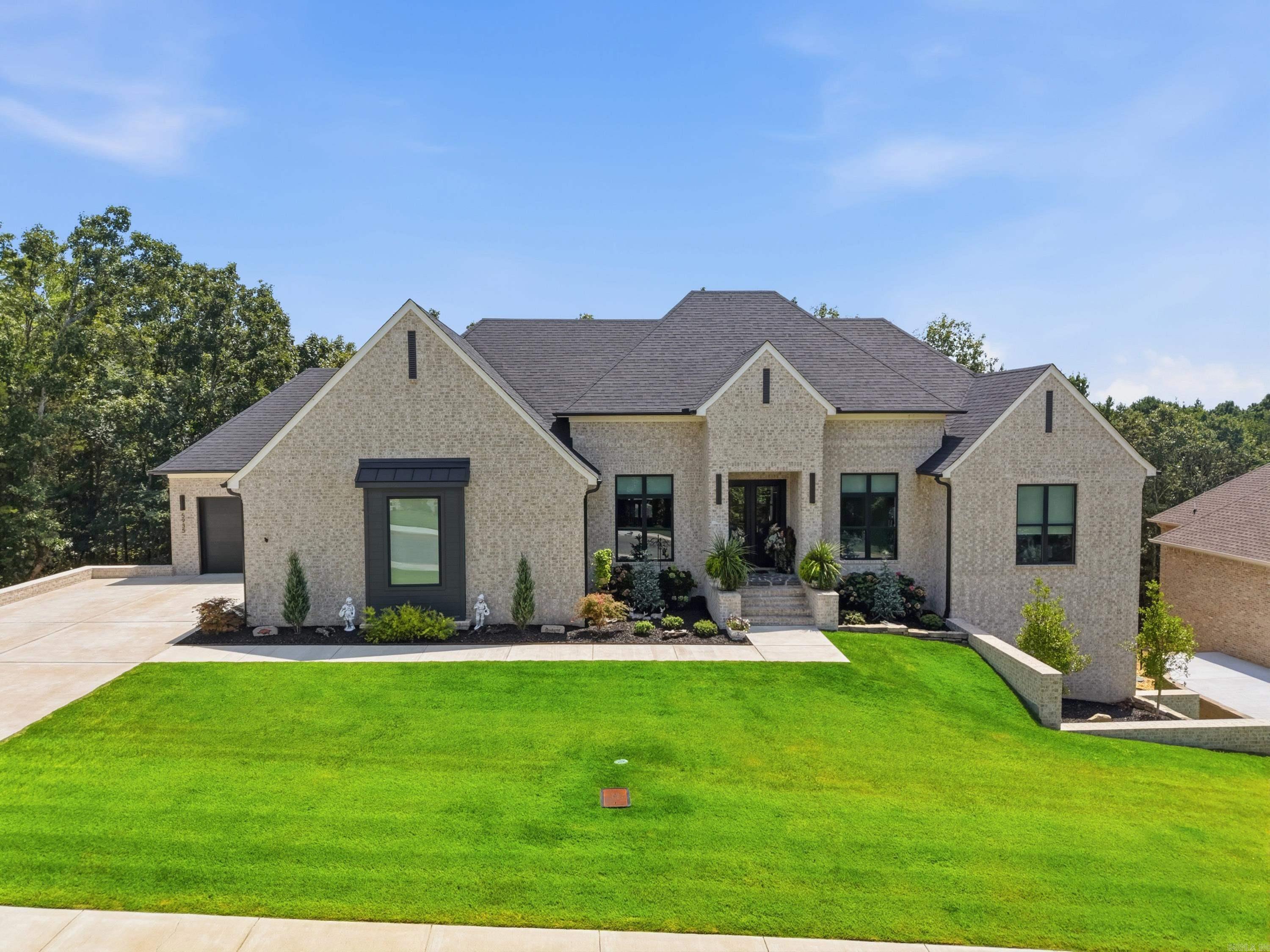 Exceptional custom built home in Spencer Mountain subdivision. This stunning 5 bed, 3 bath home w/office & 3 separate living areas sits on a beautiful lot w/a private tree-lined backdrop. The impressive foyer opens into a large living area w/beautiful accent fireplace wall. The spacious kitchen features a large center island, quartz countertops, beautiful custom cabinetry, stainless steel appliances, gas cooktop, double ovens & walk-in pantry. The large primary en suite features an oversized bedroom w/vaulted ceilings, a spa like primary bath w/separate soaking tub, double sinks & beautiful walk-in tiled shower. On the main level, 2 large guest bedrooms share a hall bath, separate office, mudroom & laundry room. Downstairs there are 2 more bedrooms, full bath & 2 large living area areas, one is 24 x 28. In addition, over 800 SF of heated & cooled unfinished space is ready to customize while still providing exceptional storage. Outside: beautiful landscaping, 2 spacious covered back porch areas overlooking the private tree-lined backyard & oversized 3 car garage complete this incredible property w/access to Spencer Lake.