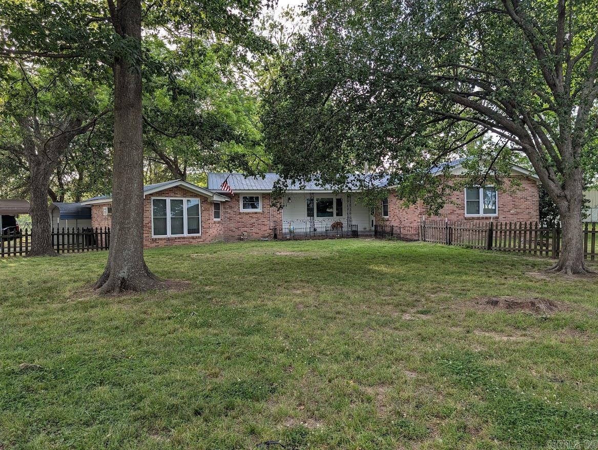 This 1,774 sq ft home is situated on 1.43 acres near the edge of town, in a small, quiet neighborhood. Spacious and move-in ready, this well-maintained home features 3 large bedrooms—two with double closets and a primary suite with a large walk-in closet and private bath with jacuzzi tub/shower. A bonus room offers the perfect space for a home office. Enjoy low-maintenance vinyl plank flooring throughout, insulated, easy-clean windows that flip out for convenience, and insulated patio doors with built-in blinds. The kitchen comes fully equipped with all appliances included. Stay comfortable year-round with a 6-year-old central HVAC system, new ductwork, air vents, and two additional A/C units. Outdoor living includes a welcoming front porch and a small back patio. Property also features a 12’x28’ storage building and a 40’x31’ shop—both with electricity. Covered parking for 3 vehicles completes this fantastic package. Don’t miss it!