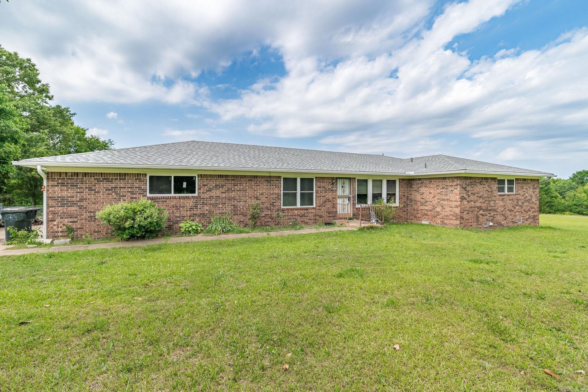 This is a versatile 3-bedroom, 2-bath property offering space, functionality, and endless potential. Situated on unrestricted acreage, this home features a fenced backyard ideal for pets and play, plus additional open land perfect for a homestead or hobby farm. Inside, you’ll find a formal dining room, a kitchen with a breakfast nook, a comfortable family room, and a separate living room highlighted by a wood-burning fireplace and stunning exposed wood beams that beautifully contrast the white ceilings. The home includes an attached two-car garage as well as a detached two-car garage currently used for storage. A large storage room located just off the laundry area offers excellent potential for a walk-in pantry or additional workspace. With abundant room to personalize and priced to sell quickly, this property is ready for its next chapter.