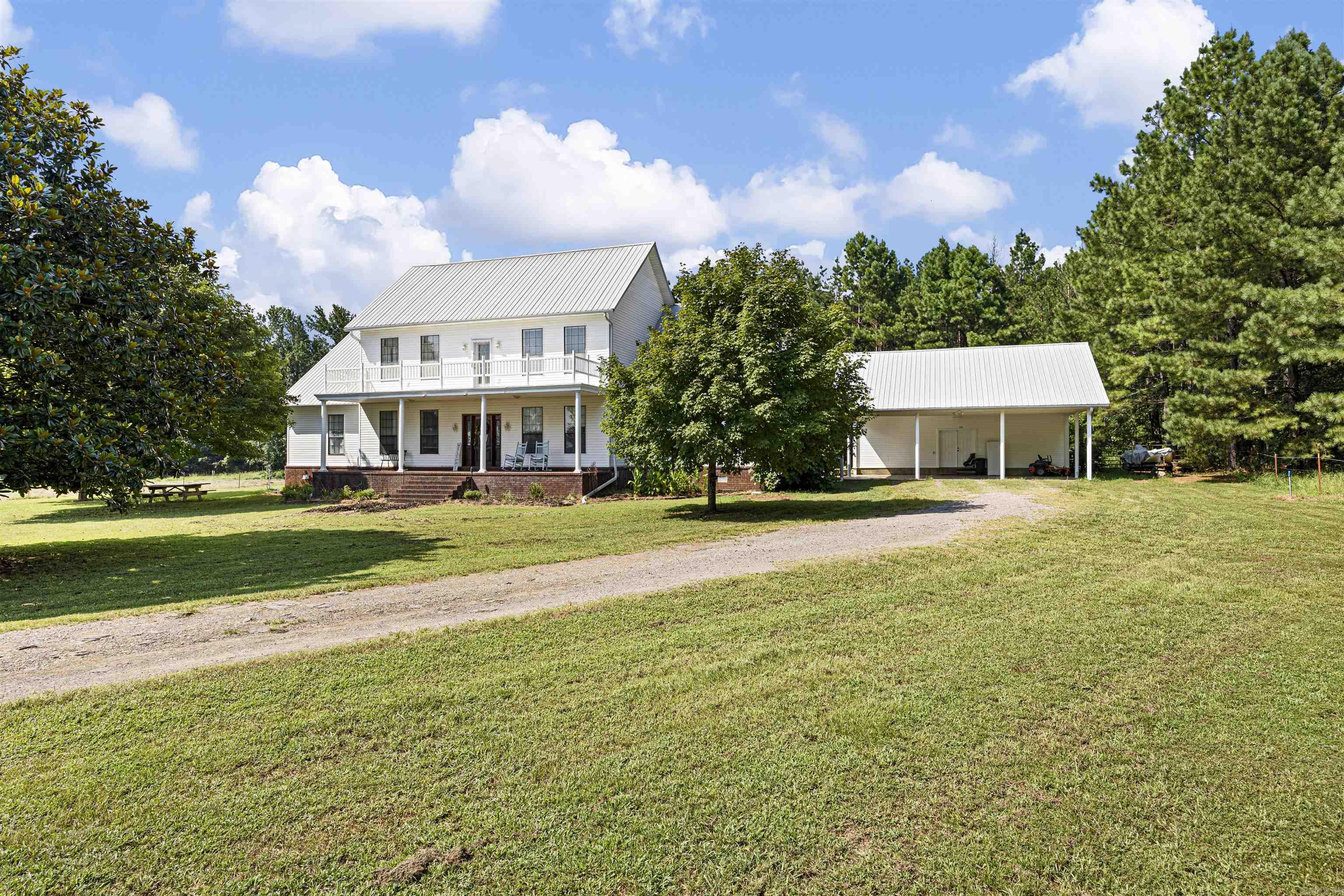 Come and experience the charm of this stunning 5-bedroom, 3-bath home offering 3,539 sq ft of beautifully designed living space. Step into a welcoming living area with soaring cathedral ceilings and a cozy wood-burning fireplace—perfect for relaxing evenings. The eat-in kitchen features granite countertops, double ovens, and plenty of counterspace for entertaining. Enjoy your morning coffee on the covered front porch while taking in the serene views of the surrounding pasture and wooded landscape. This home also includes a dedicated study, a sunroom filled with natural light, and a formal dining room, providing plenty of space for both work and play. Nestled on 19.88 acres +/- of rolling pasture and woods, with a barn. It's the perfect blend of comfort, privacy, and natural beauty. Don’t miss out—schedule your private showing today!