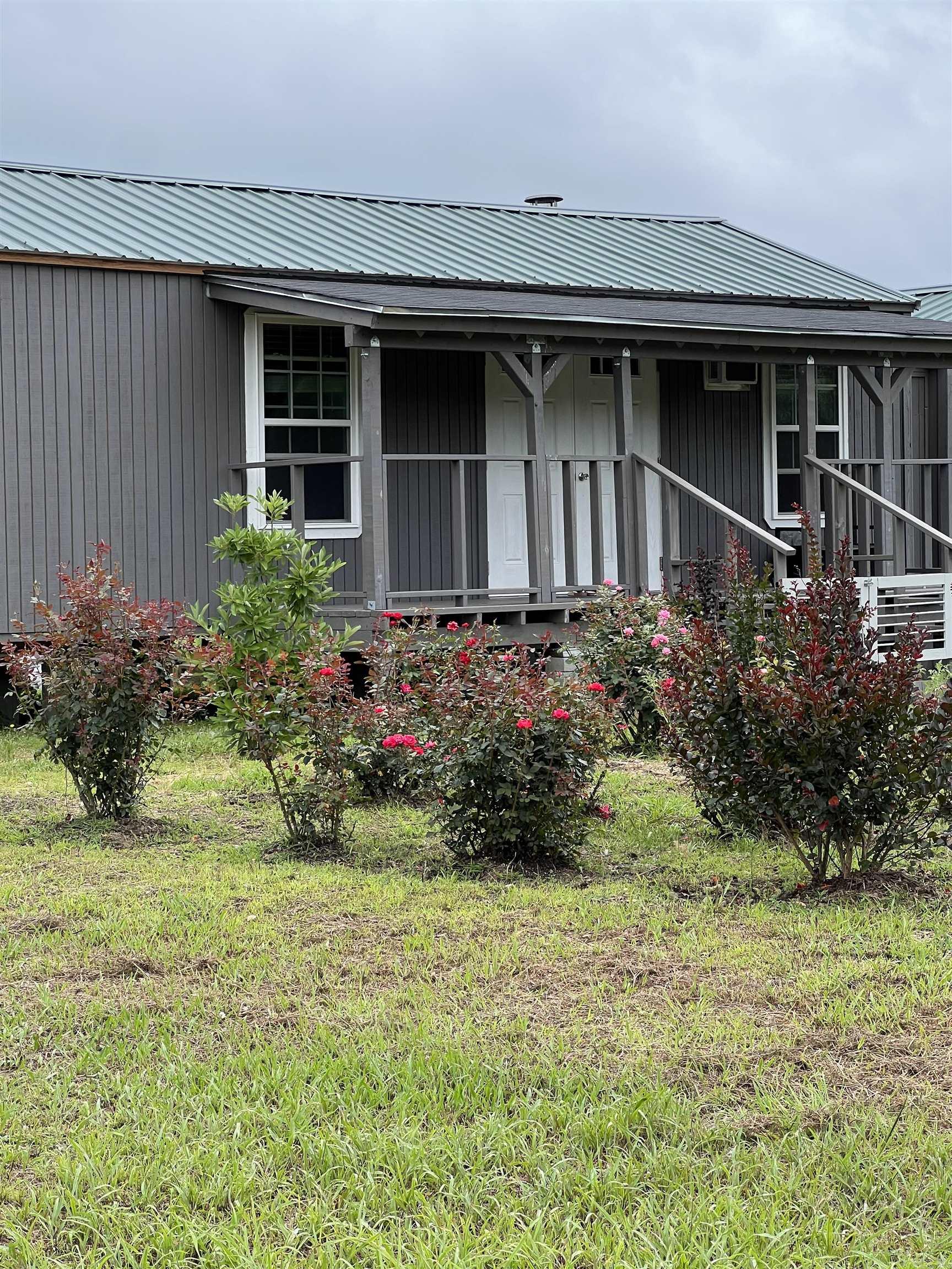 Whether you’re looking for a full-time residence, weekend getaway, or homestead opportunity, this unique property offers endless possibilities .Escape to the peace and privacy of this beautiful 12.57 acre property featuring two Tiny homes combined into one spacious residence, offering 3 bed and 2 bath. Enjoy the scenic surroundings with plenty of room to garden, raise animals, or simply enjoy nature. The property offers a wonderful blend of open space and wooded views, giving you the feeling of seclusion while still being conveniently accessible.