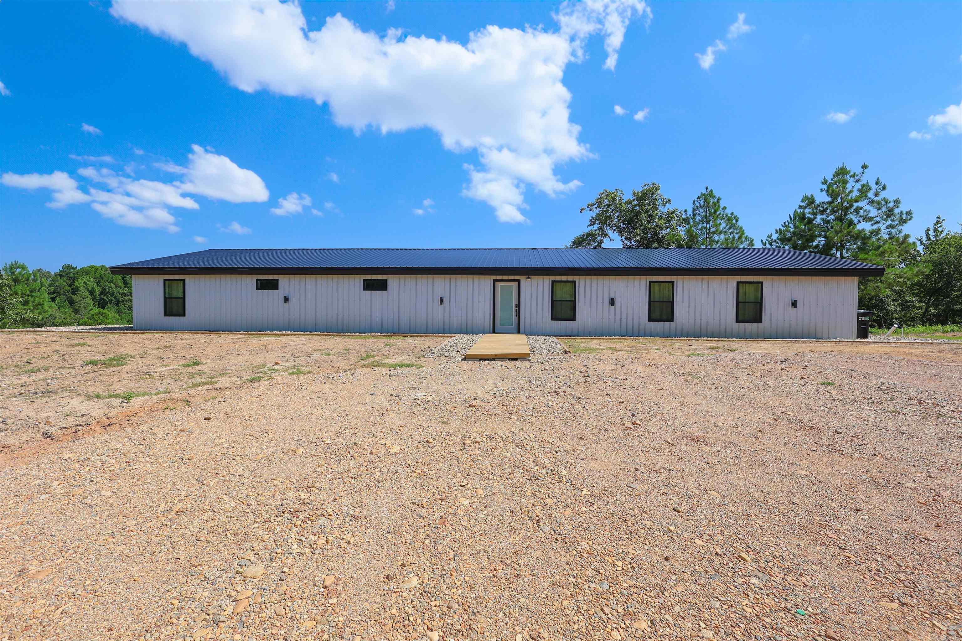 Escape to a stunning new construction home built in 2026. It is located in the Greeson Acres Subdivision less than a mile away from Self Creek on Lake Greeson. The home was designed with a modern industrial aesthetic. Showcasing the open ceiling rafters, this 3 bedroom, 2 bath home sits on 3.8 acres. This home is currently set up as a successful Airbnb, this turnkey property comes fully furnished and ready for immediate enjoyment or continued rental income. Whether you're looking for a private escape, a vacation home, or a proven short-term rental opportunity, this modern retreat delivers the perfect combination of style, serenity, and location.