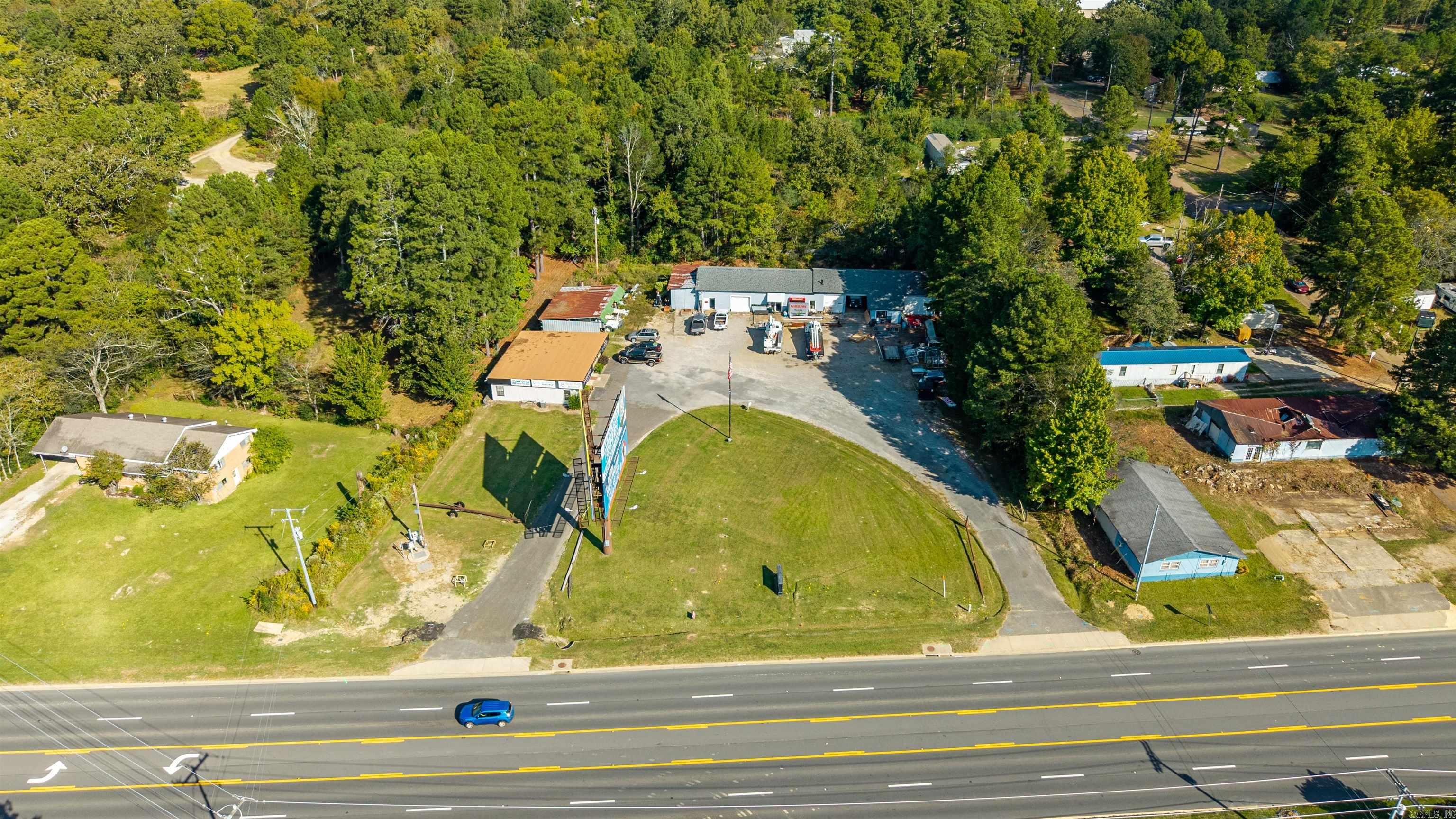 1.7 acres with 1656 sq ft w/4 offices and nice reception area. Warehouse shop 4200 sq ft with 4 overhead doors and bathroom. 255’ airport rd frontage with traffic account over 22,000 per day.