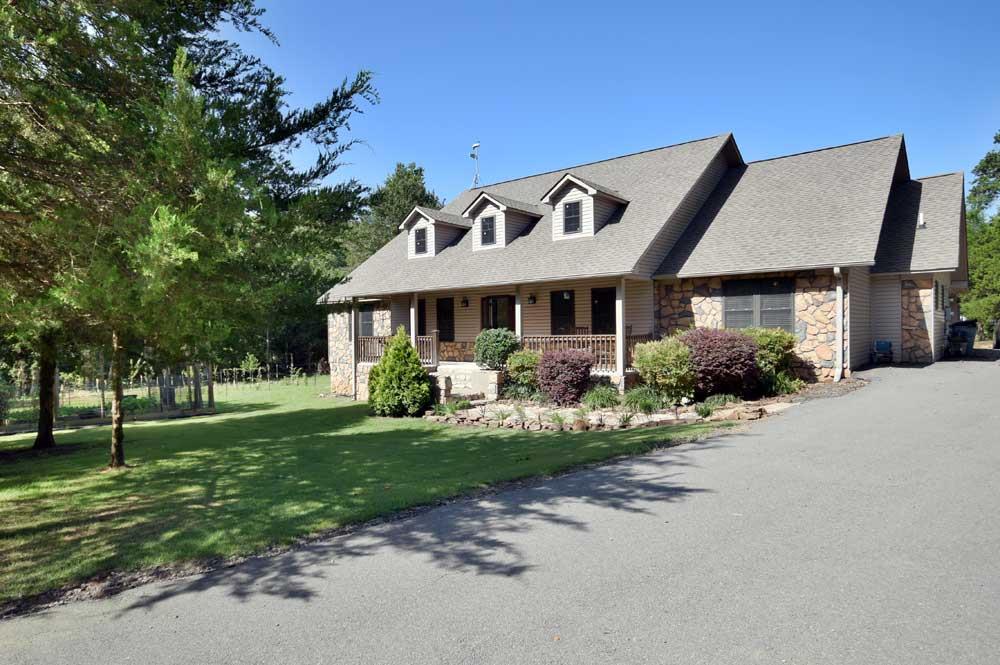 Peaceful, private country living complete with fruit trees, blackberry orchard, garden spot and a large pond stocked with catfish. Just behind the pond you have a deer plot and a seasonal creek. The kitchen is ready for your harvest with a large farmers pantry and tons of counter and cabinet space. Home offers office and a third bedroom which could function as mother-n-law suite. Nice deck overlooking pond for lots of family fun. Storage shed has chicken coop attached. Home is handicap accessible.See Remark