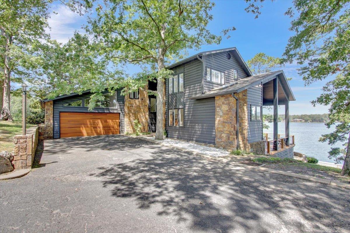 Architecturally Designed Contemporary on Extraordinary Lake Hamilton Lot!  The Home Has Been Beautifully Refurbished and Has POSTCARD Views of of the Lake and Mountains!!!  Lot is 1.6 acres, So Offers the Ultimate Privacy and Plenty of Room to Roam and Build a Bunkhouse or Guesthouse. Inside the House are 3 or 4 BR and a Fabulous Kitchen with Butlers Pantry/Office/Prep Kitchen.The Living Area is Fabulous with Volume Ceiling, Wall of Glass and Electric Fireplace (2nd fireplace is WBF and is in kitchen).  All Bedrooms are Nice Sized and 4th Room is Game Room or 4th BR/Bunkroom.  Utility Room is also a Doggie Spa.  Designed with the Discriminating  Pet in Mind. Outside the Decks are Spacious and the View Engulfing. Incredible Flagstone Patio....Perfect Spot for a Fire Pit!  Large Permitted Boat Dock Too!